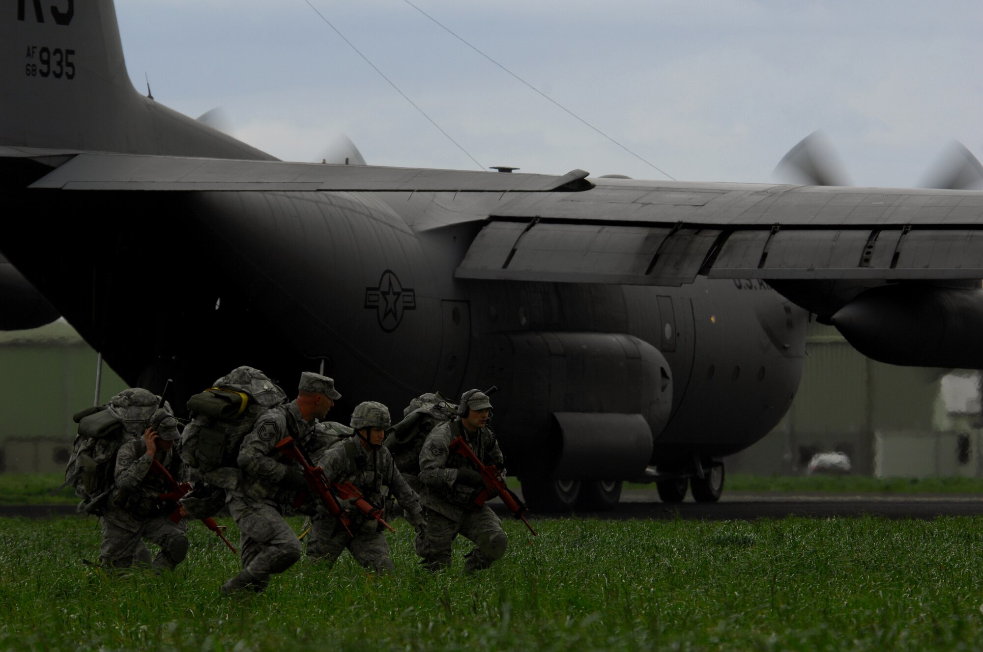 United States Air Force airmen with the 86th Contingency Response Group, rapidly deploy from a C-130 Hercules to begin assessing an airfield during an Operational Readiness Exercise, May 18, 2009, West Freugh Airfield, Scotland. (U.S. Air Force photo by Senior Airman Kenny Holston)