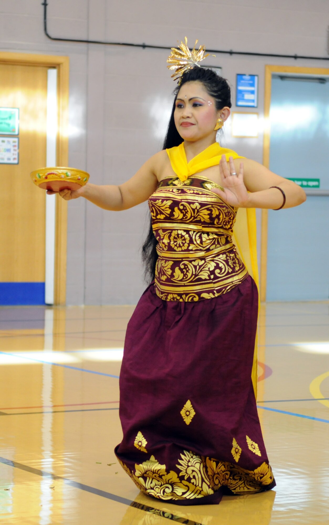 Juli Gusler performs a Balinese dance during a Hearts Apart event May 20.  American and British families of deployed servicemembers were invited to the event to foster a sense of community among military dependents.  (U.S. Air Force photo by Staff Sgt. Austin M. May)