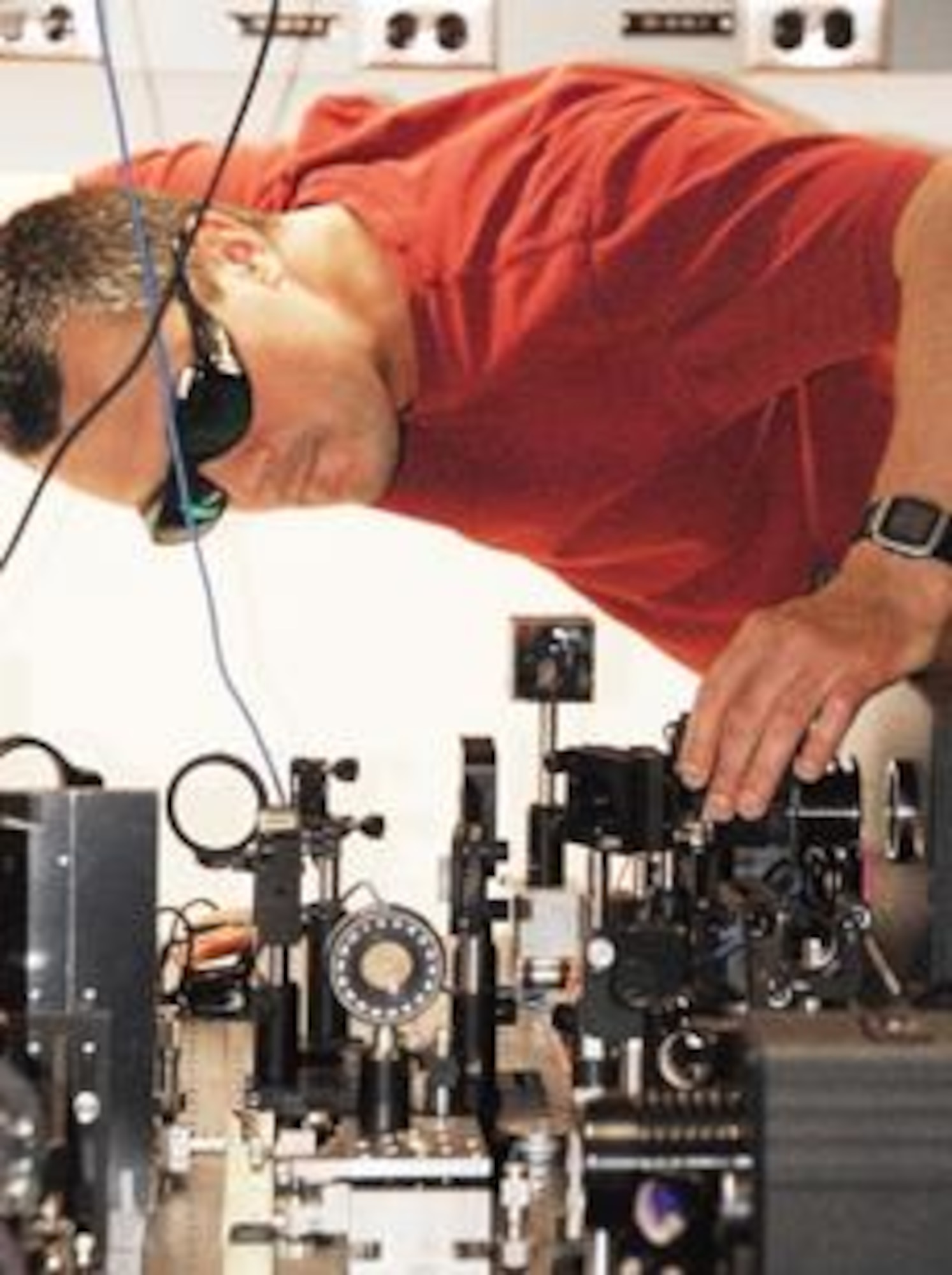 Dr. Pavel Polynkin aligning beam-shaping optics used in experiments. Credit: Kelly King, University of Arizona