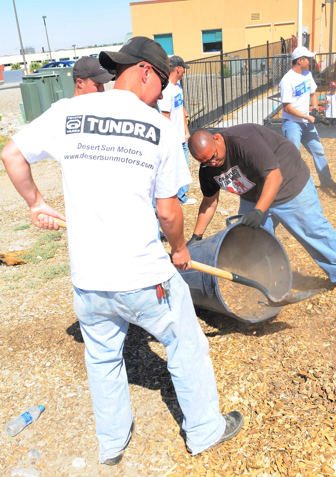 Volunteers from Holloman Air Force Base, N.M., place new woodchips on the playground of the Gerald Champion Child Development Center during the United Way of Otero County Day of Caring in Alamogordo, N.M, May 7. There were 341 Holloman volunteers who directly supported 52 families and a number of local organizations. (U.S. Air Force photo/ Airman 1st Class DeAndre Curtiss)