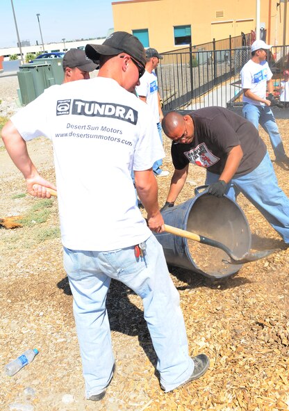 Volunteers from Holloman Air Force Base, N.M., place new woodchips on the playground of the Gerald Champion Child Development Center during the United Way of Otero County Day of Caring in Alamogordo, N.M, May 7. There were 341 Holloman volunteers who directly supported 52 families and a number of local organizations. (U.S. Air Force photo/ Airman 1st Class DeAndre Curtiss)