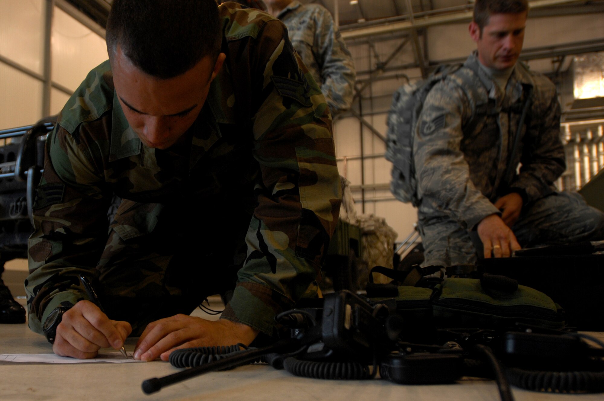 United States Air Force Senior Airman Nick Hurst, 786th Security Forces Squadron patrolman, fills out forms for additional radios in preparation for an Operational Readiness Exercise, May 17, 2009, RAF Fairford, England. Airman Hurst and his team participated in the ORE for seven days between West Freugh Airfield, Scotland and RAF Fairford, England on how to safely and effectively take over an airfield and set it up for operational capabilities. (U.S. Air Force photo by Senior Airman Kenny Holston)