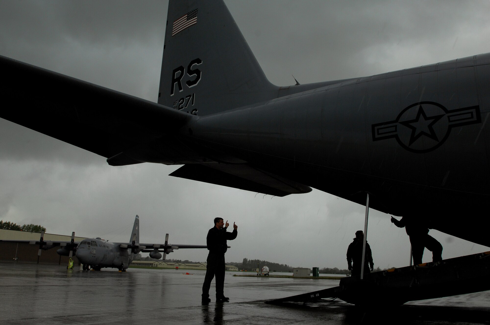 United States Air Force crew chiefs and loadmasters with the 37th Airlift Squadron, discuss how much room is needed to load cargo on to a C-130 Hercules in support of an Operational Readiness Exercise, May 17, 2009, RAF Fairford, England. The C-130 was later flown to West Freugh Airfield, Scotland, loaded with cargo to begin the ORE. (U.S. Air Force photo by Senior Airman Kenny Holston)