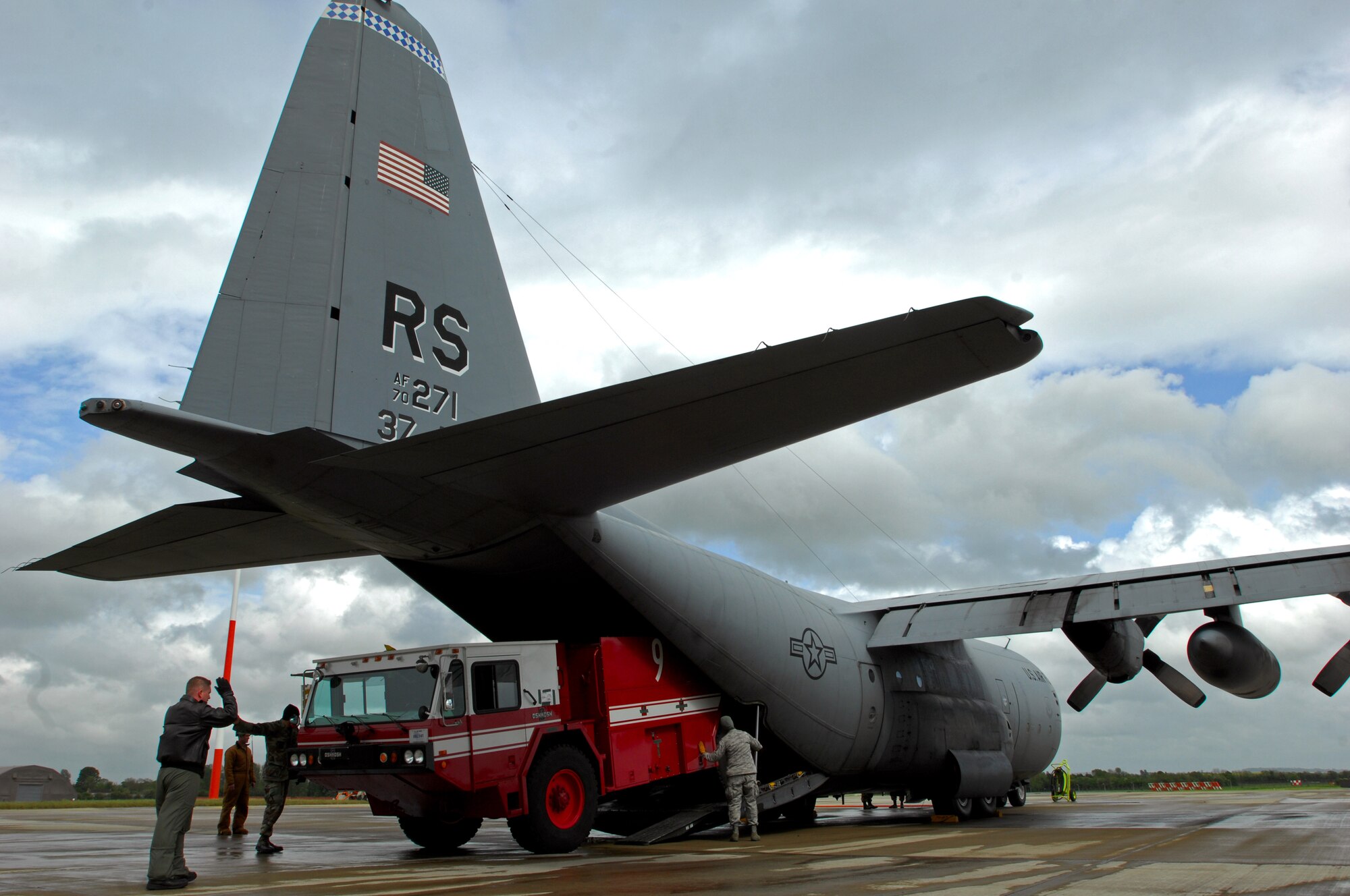 United States Air Force crew chiefs and loadmasters with the 37th Airlift Squadron and firefighters with the 835th Civil Engineer Squadron, load a fire truck on to a C-130 Hercules in support of an Operational Readiness Exercise, May 17, 2009, RAF Fairford, England. The fire truck was then flown to West Freugh Airfield, Scotland to begin the ORE. (U.S. Air Force photo by Senior Airman Kenny Holston)