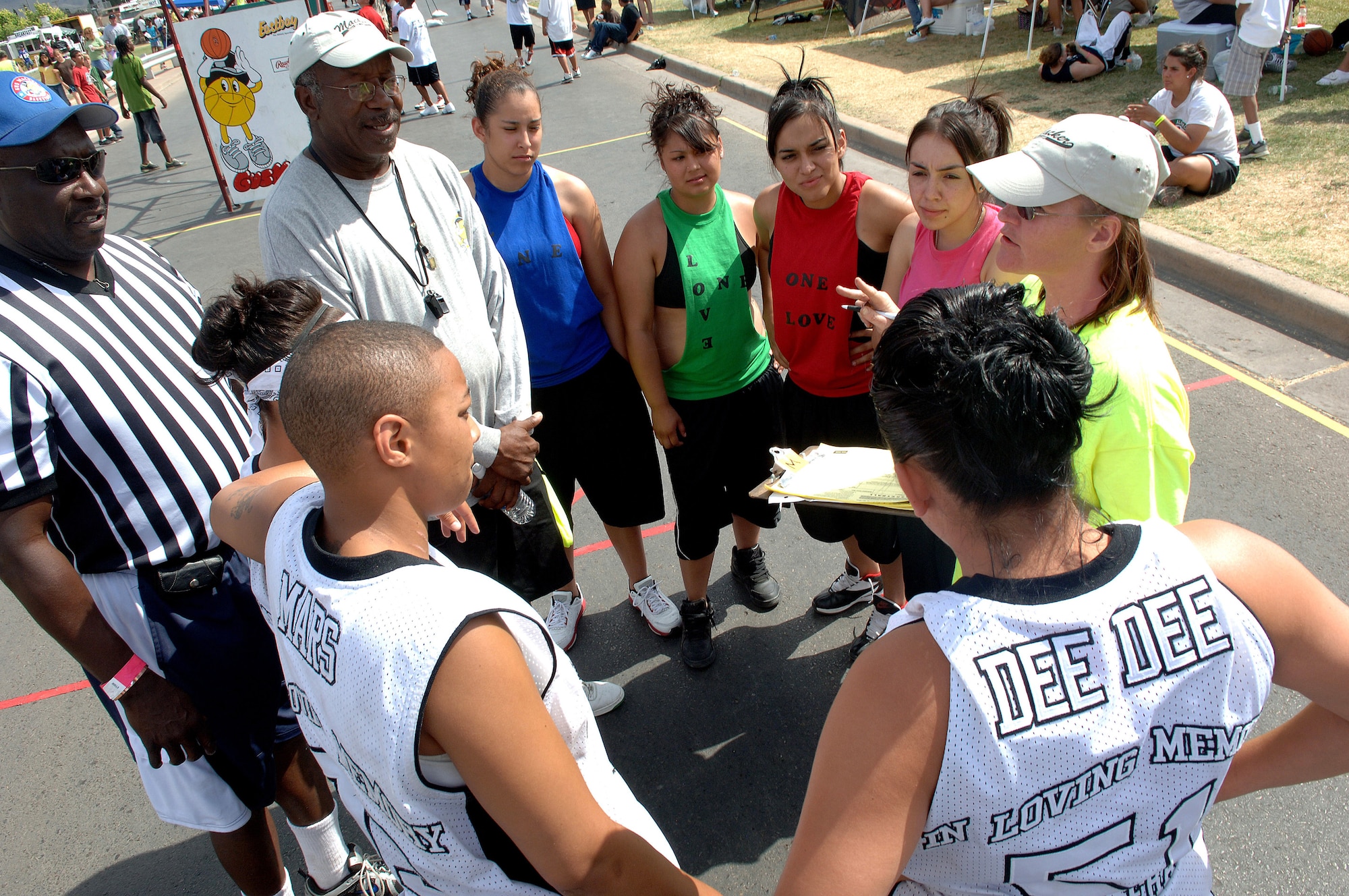 Both Panthers and One Love team members from Las Cruces, N.M., gather in a circle to hear rules before playing against one another during Saturday in the Park/Armed Forces Day Celebration at Washington Park in Alamogordo, N.M., May 16. Games for the Gus Macker event started as early as 8:00 a.m. with games lasting until Sunday. (U.S. Air Force photo/Airman 1st Class Veronica Stamps)