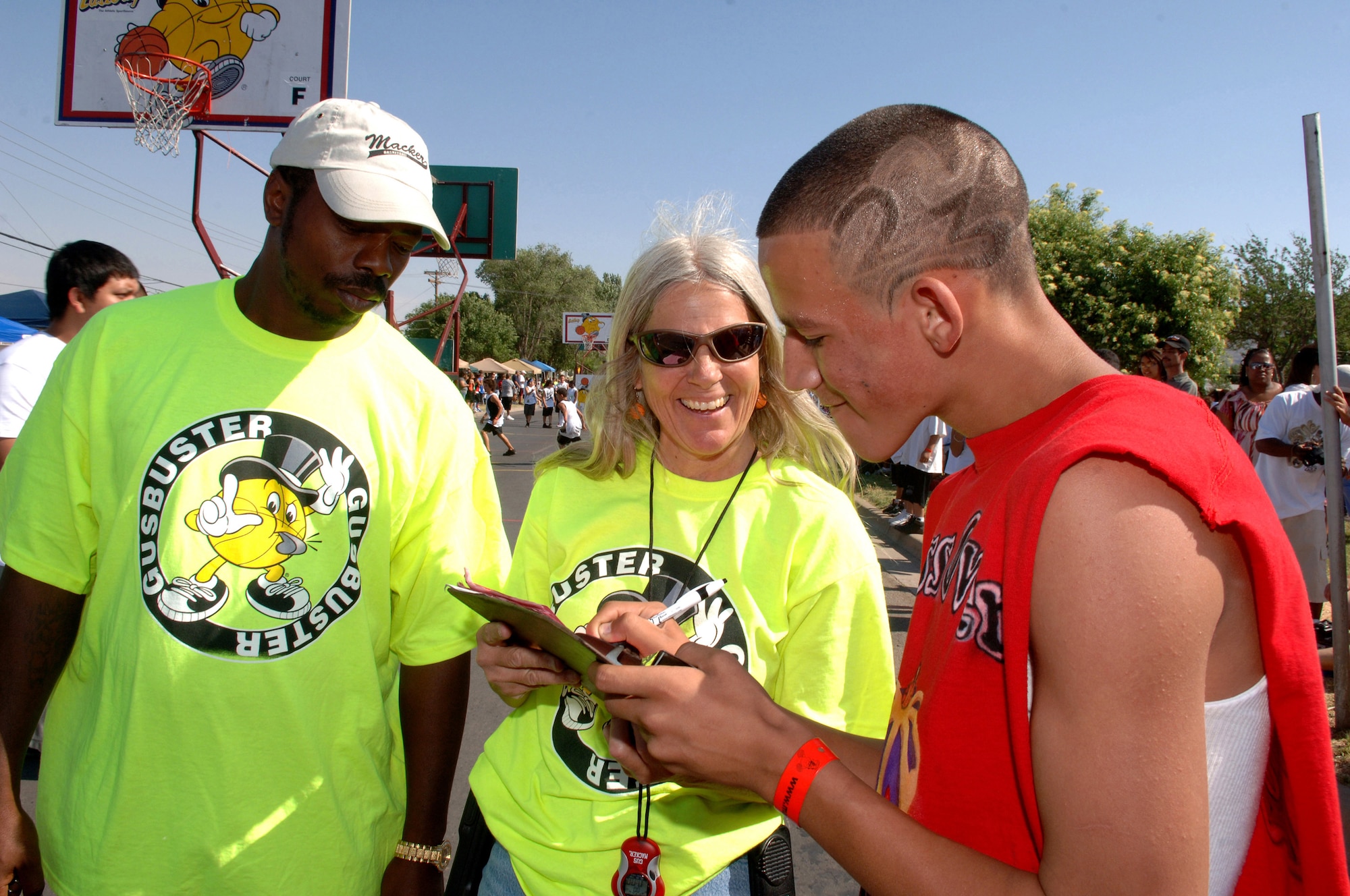 Steven Rodrigues from the Kross Over Kings team of Alamogordo, N.M., signs his team onto the score sheet after competing in a basketball game during Saturday in the Park/ Armed Forces Day Celebration at Washington Park in Alamogordo, N.M., May 16.The city of Alamogordo refereed boys and girls basketball teams of all ages. (U.S. Air Force photo/ Airman 1st Class Veronica Stamps) 
