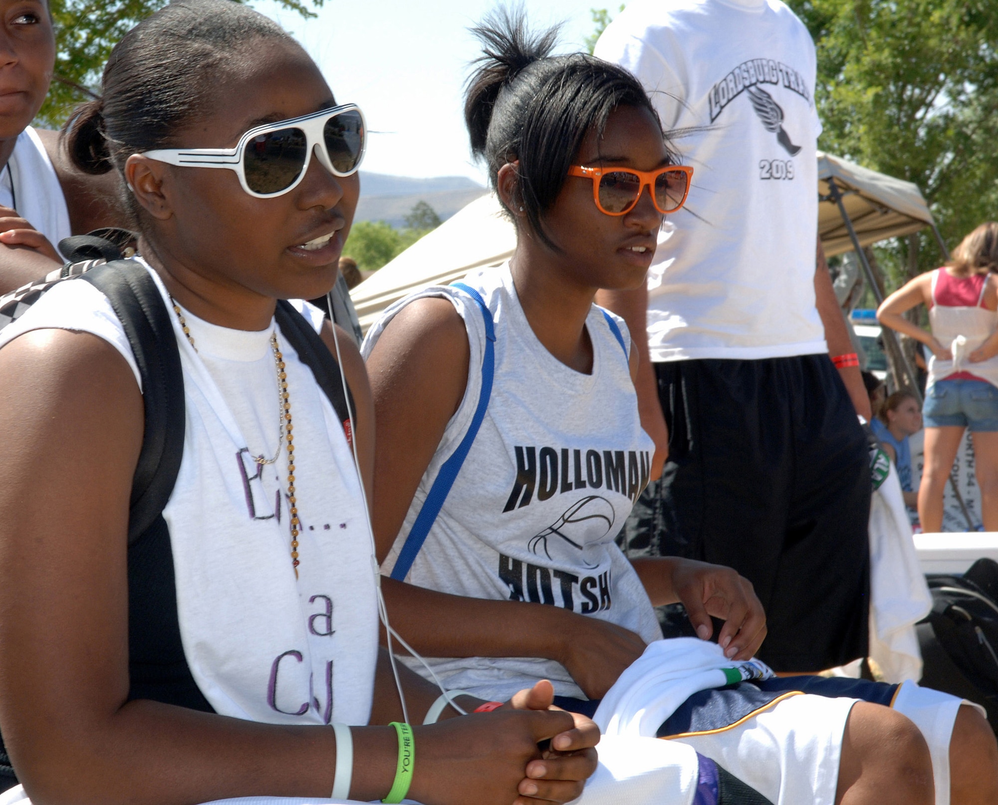 Erica Jackson, from the Holloman Hot Shots team of Holloman Air Force Base, N.M., and Cayla Blue, of the Outa Control team of Alamogordo, N.M., watch their teammates compete during Saturday in the Park/Armed Forces Day Celebration at Washington Park in Alamogordo, N.M., May 15. Teams from around New Mexico participated in the Gus Macker event along with music, food and rides for the public. (U.S. Air Force photo/Airman 1st Class Veronica Stamps)