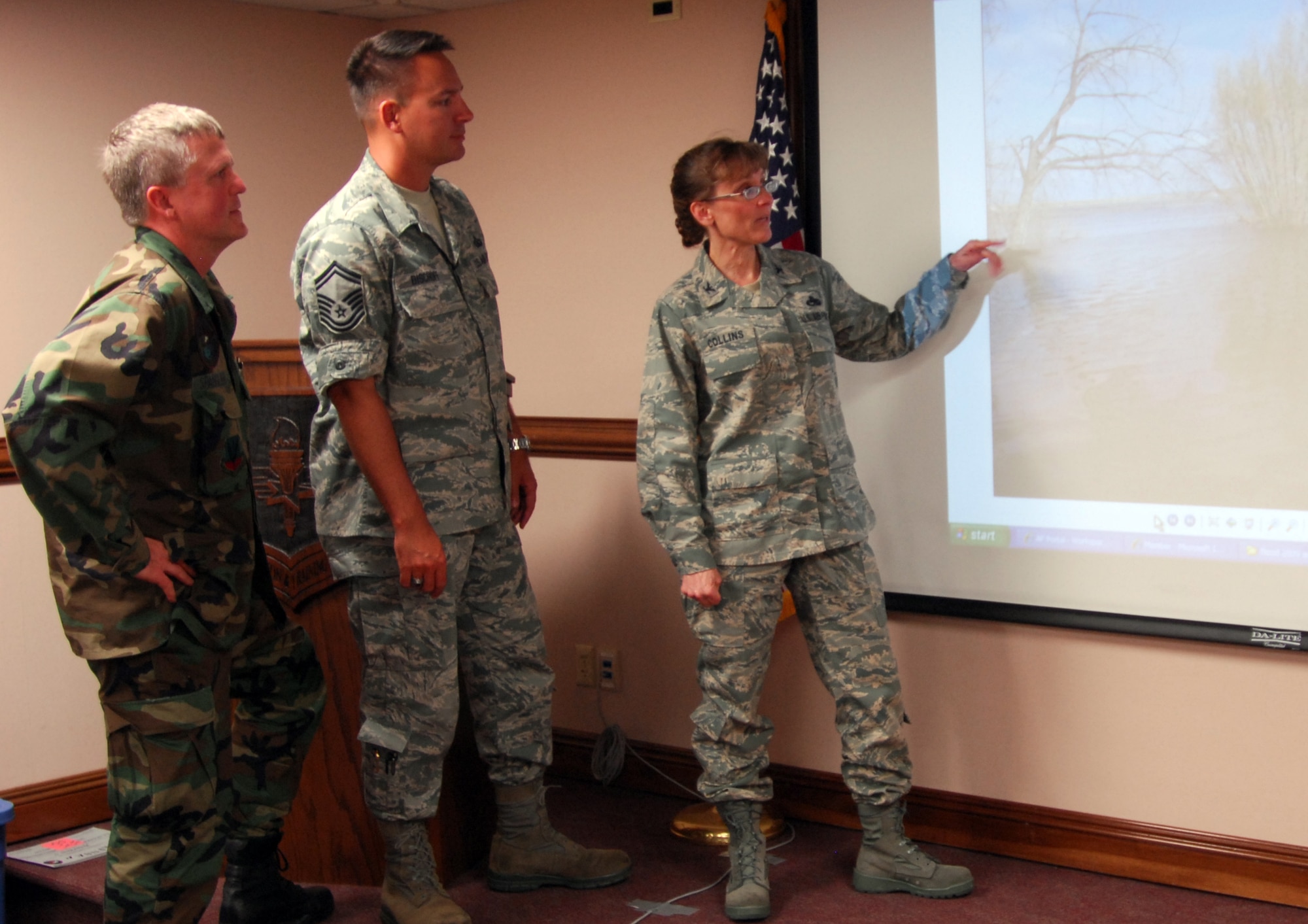 Air Force Emergency Preparedness Liaison Officer Col. Stacy Collins, right, discusses the North Dakota flood with Col. Jon Spangler, left, and Senior Master Sgt. Brian Bischoff, all of whom attended a recent EPLO orientation at Tyndall AFB. U.S. Air Force Photo by Lisa Norman

