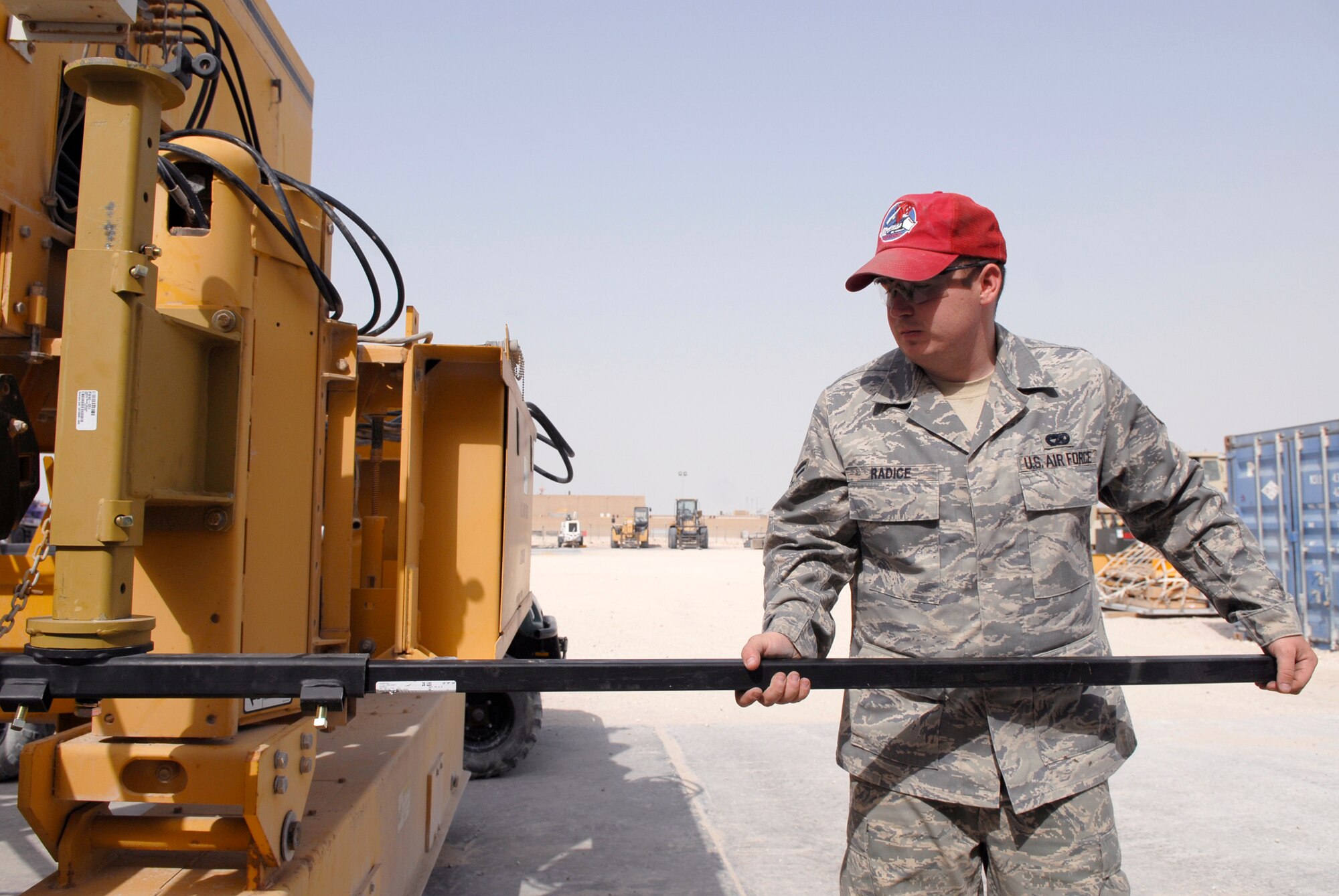 Senior Airman Marc Radice, 1st Expeditionary RED HORSE Group (ERHG) Vehicle and Equipment Mechanic, attaches a grade and elevation sensor mount onto a Gomaco Paver during a routine inspection, May 20, 2009, at an undisclosed location in Southwest Asia.  The paver is being prepared for shipment to a forward location in the U.S. Central Command's area of Responsibility.  Airman Radice hails from Milledgeville, Ga. and is deployed from Malmstrom Air Force Base, Mont. in support of Operations Iraqi and Enduring Freedom and Combined Joint Task Force - Horn of Africa.  (U.S. Air Force photo/Senior Airman Andrew Satran/released)