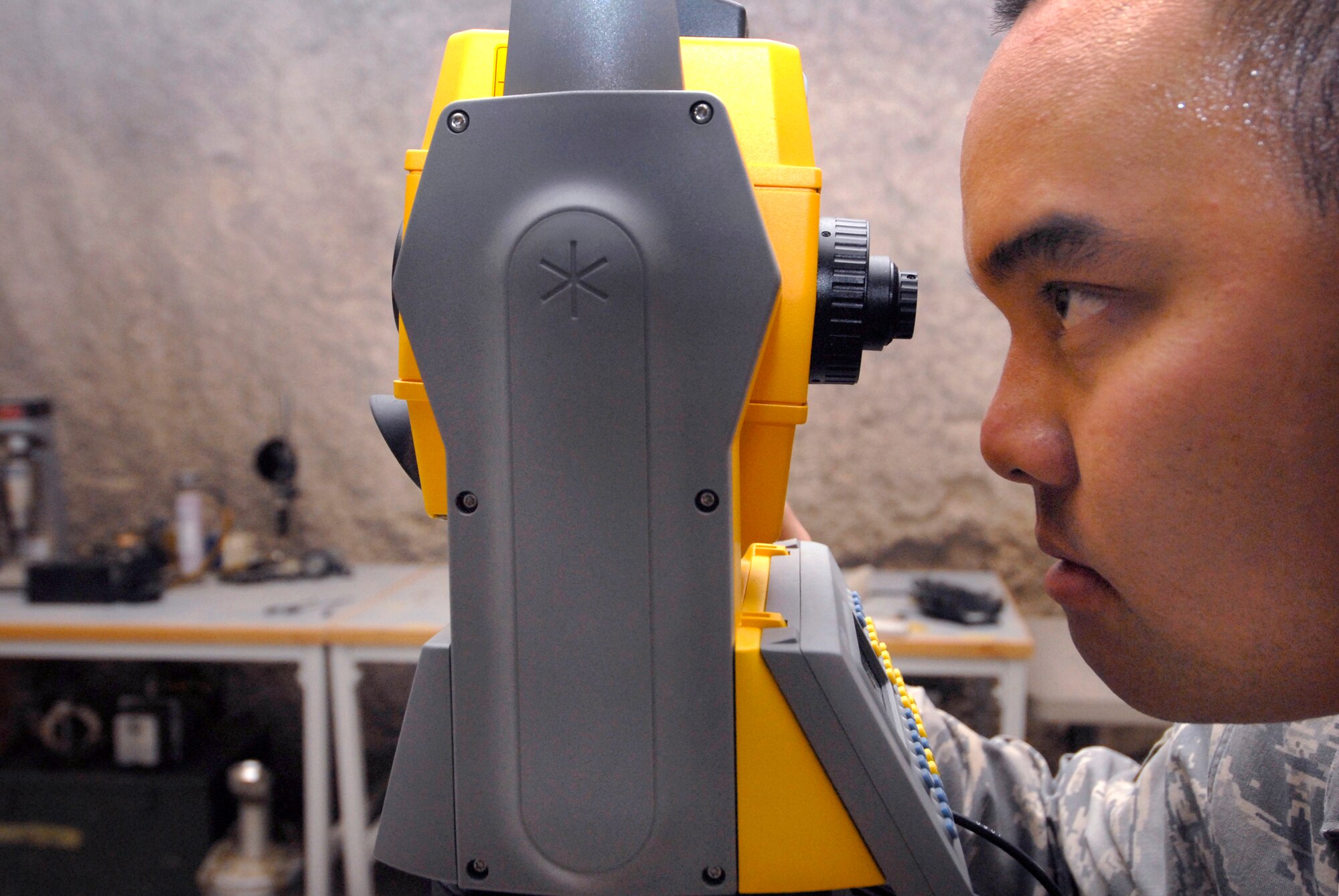Senior Airman Tien Tran, a 1st Expeditionary RED HORSE Group engineer technician, function checks a geodimeter, May 20, 2009, at an undisclosed location in Southwest Asia.  The geodimeter is used to survey elevations, angles, and distances on construction projects.  The geodimeter will be sent on to Red Horse Airmen for use in a forward deployed location in the U.S. Central Command's area of responsibility.  Airman Tran hails from Fairfax, Va. and is deployed from Malmstrom Air Force Base, Mont. in support of Operations Iraqi and Enduring Freedom and Combined Joint Task Force - Horn of Africa.  (U.S. Air Force photo/Senior Airman Andrew Satran/released)