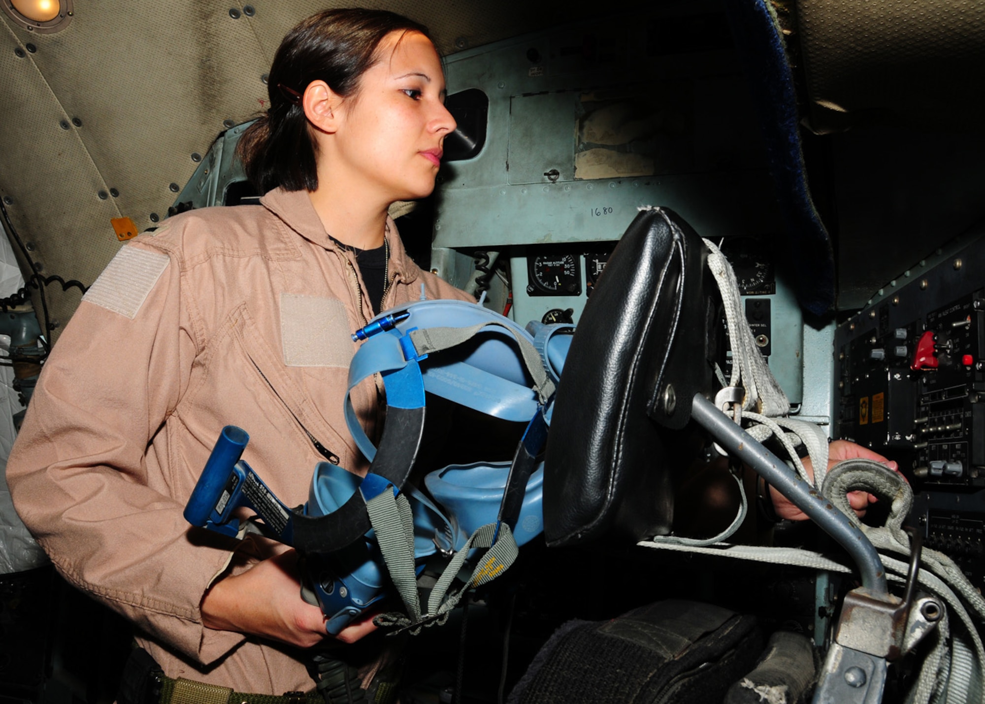 SOUTHWEST ASIA -- 1st Lt. Jennifer Sherwood, 737th Expeditionary Airlift Squadron navigator, preflights her oxygen mask at an air base in Southwest Asia, May 19. During the check, Lieutenant Sherwood is making sure the hose is in good condition, the mask creates a seal on her face and the oxygen flows at the required rate. Lieutenant Sherwood is currently deployed from Yokota Air Base, Japan, and is originally from El Dorado, Kan. (U.S. Air Force photo/ Senior Airman Courtney Richardson)