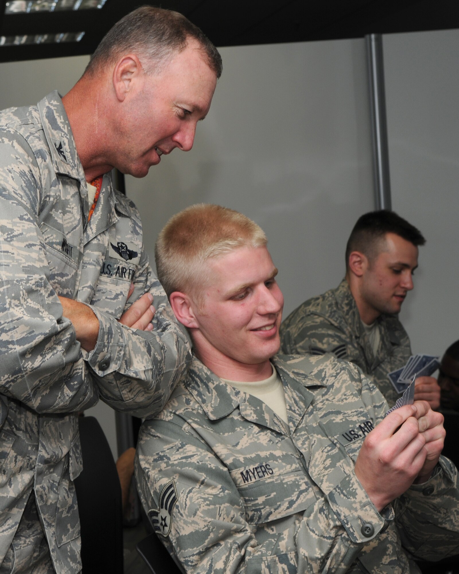 SPANGDAHLEM AIR BASE, Germany – Col. Lee T. Wight, 52nd Fighter Wing commander, takes a look at Senior Airman Greggory Myers, 52nd Equipment Maintenance Squadron, cards during a game May 19, 2009.  Sabers found many ways to pass the time waiting for their flight to various locations downrange to support overseas contingency operations.  (U.S. Air Force photo by Staff Sgt. Heather M. Norris)