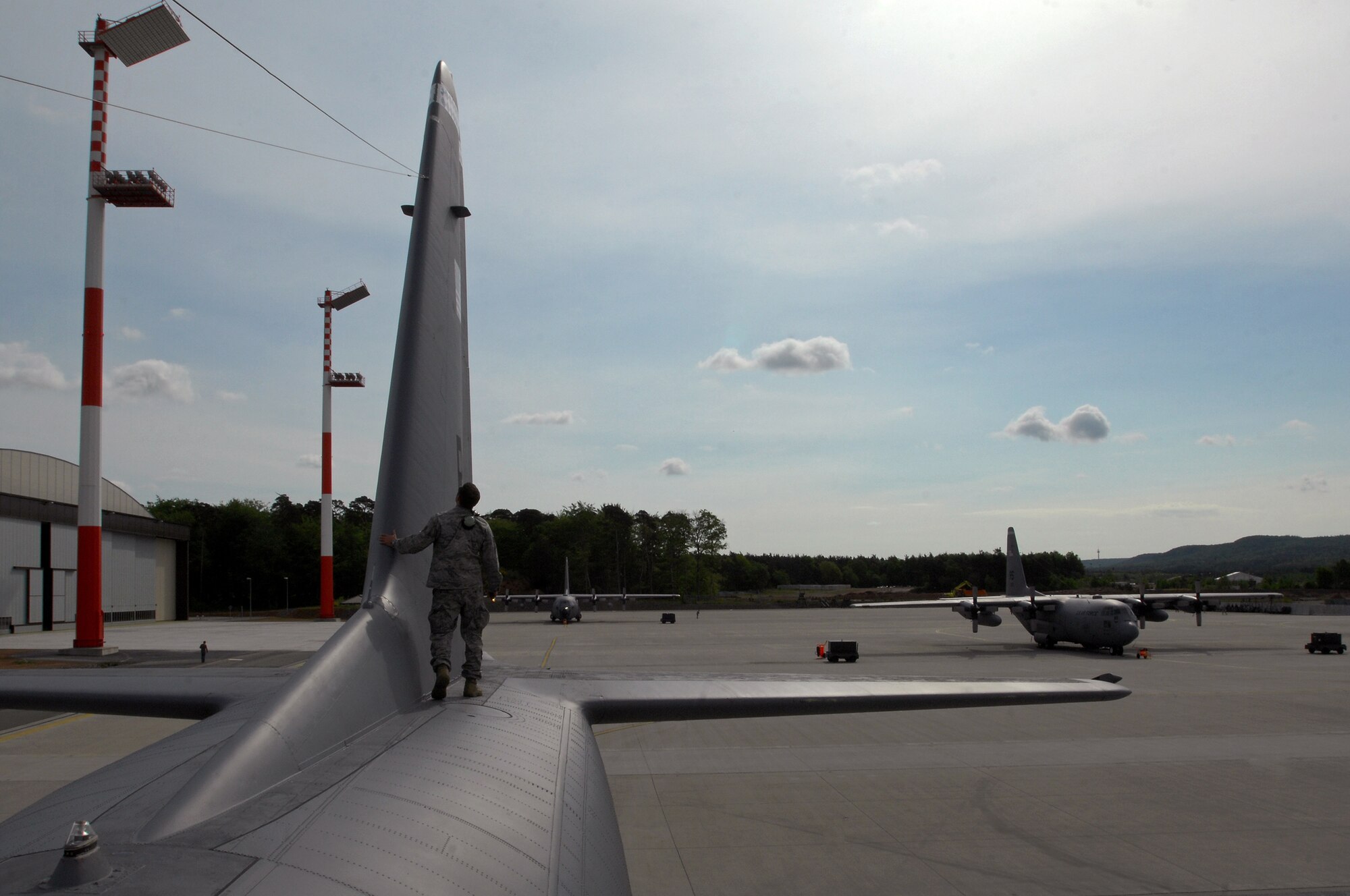 United States Air Force Staff Sgt. Giovanni Bosch 86th Aircraft Maintenance Squadron crew chief, performs a pre-flight inspection on a C-130 Hercules, May 8, 2009, Ramstein Air Base, Germany. (U.S. Air Force photo by Senior Airman Kenny Holston)