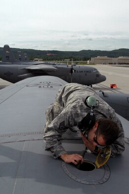 United States Air Force Staff Sgt. Giovanni Bosch 86th Aircraft Maintenance Squadron crew chief, performs a pre-flight inspection on a C-130 Hercules, May 8, 2009, Ramstein Air Base, Germany. (U.S. Air Force photo by Senior Airman Kenny Holston)
