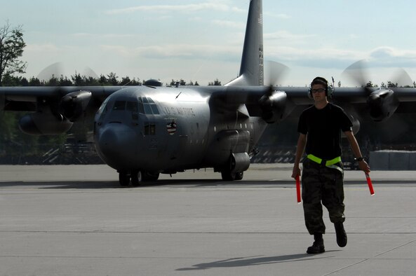 Airman 1st Class Joshua Harkin, 86th Aircraft Maintenance Squadron crew chief, prepares to marshal a C-130 Hercules to take off, May 8, 2009, Ramstein Air Base, Germany. (U.S. Air Force photo by Senior Airman Kenny Holston)