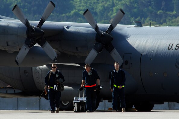 United States Air Force maintainers with the 86th Aircraft Maintenance Squadron walk off the Ramstein flightline after performing maintenance on a C-130 Hercules, May 8, 2009, Ramstein Air Base, Germany. (U.S. Air Force photo by Senior Airman Kenny Holston)