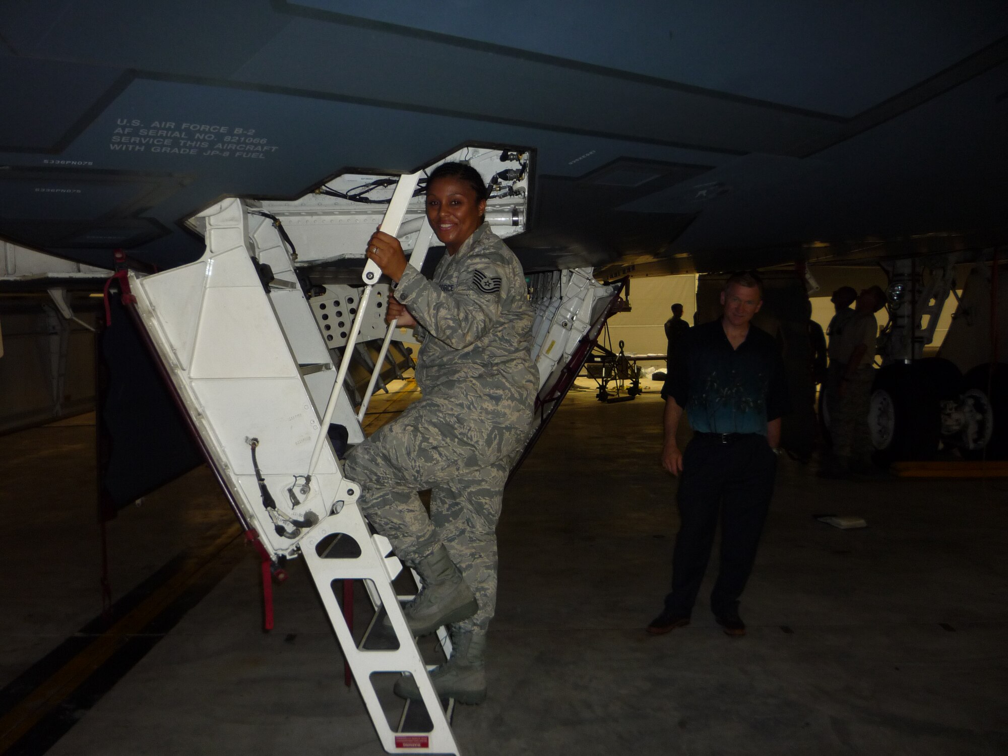 ANDERSEN AIR FORCE BASE, Guam -- Tech. Sgt. Taine Reed, 506th Expeditionary Air Refueling Squadron client support administrator assistant, climbs up a B-2 Spirit flight deck during a tour the 13th Expeditionary Bomb Squadron provided to 506th EARS. The reserve unit refuels the bombers deployed here. Sergeant Reed is a Long Beach, Calif., native deployed from March Air Reserve Base, Calif.  (U.S. Air Force photo by Staff Sgt. Erin C. Phillips) 