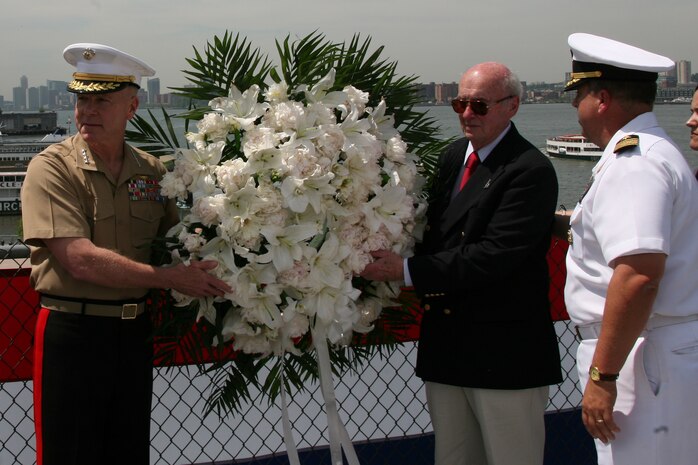 NEW YORK - Assistant commandant of the Marine Corps, Gen. James F. Amos, Iwo Jima veteran Cpl. Allen Striffler and commanding officer of the USS Iwo Jima Navy Captain Jeffrey Charles Amick prepare to throw a wreath over the side of the USS Intrepid to honor the Marines and Sailors who died defending their country.(Official Marine Corps photo by Sgt. Steve Cushman)
