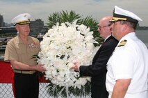 NEW YORK - Assistant commandant of the Marine Corps, Gen. James F. Amos, Iwo Jima veteran Cpl. Allen Striffler and commanding officer of the USS Iwo Jima Navy Captain Jeffrey Charles Amick prepare to throw a wreath over the side of the USS Intrepid to honor the Marines and Sailors who died defending their country.(Official Marine Corps photo by Sgt. Steve Cushman)