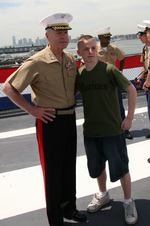 NEW YORK - Assistant commandant of the Marine Corps, Gen. James F. Amos poses for a photo with a young New Yorker at the USS Intrepid May 22. Amos was attending a wreath laying ceremony at the Intrepid. (Official Marine Corps photo by Sgt. Steve Cushman)
