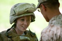 Tasha Adkins, a visitor from Gallipolis, Ohio, tries on body armor to get a feeling of what it is like to be a Marine during Marine Day in Central Park May 21. This event was just one of many the Marines of 24th Marine Expeditionary Unit and Special Purpose Marine Air Ground Task Force - New York will participate in during Fleet Week. (Official Marine Corps photo by: Cpl. Patrick Fleischman)
