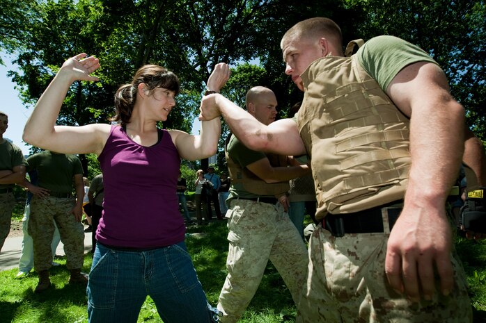 Jenel Farrell, a librarian from Manhattan, is shown how to conduct an arm-bar takedown as part of a demonstration of the Marine Corps Martial Arts Program during Marine Day in Central Park May 21. This event was just one of many the Marines of 24th Marine Expeditionary Unit and Special Purpose Marine Air Ground Task Force - New York will participate in during Fleet Week. (Official Marine Corps photo by: Cpl. Patrick Fleischman)