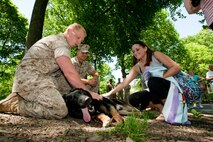 Lance Cpl. Gary Rowan, from Adel, Ga., and Cpl. Jakob Holes, from Thomasville, Ga., both military working dog handlers, take a break with their dog and show visitors how well trained and friendly the dogs are following a demonstration of how military working dogs take down an opponent during Marine Day in Central Park May 21. This event was just one of many the Marines of 24th Marine Expeditionary Unit and Special Purpose Marine Air Ground Task Force - New York will participate in during Fleet Week. (Official Marine Corps photo by: Cpl. Patrick Fleischman)