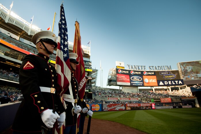 Sgt. Evan Beaule, from Lewiston, Maine, and Cpl. Matthew Burrows, from McMinaville, Tenn., both fire direction and control specialists, and Lance Cpl. Jason Carroll, from Milford, Ma., and Pfc. Jesse Jernigan, from Gates County, N.C., both artillery survey specialists, stand ready to bring the colors on to the field of Yankee Stadium for the playing of the National Anthem May 22. This event was just one of many the Marines of 24th Marine Expeditionary Unit and Special Purpose Marine Air Ground Task Force - New York will participate in during Fleet Week.