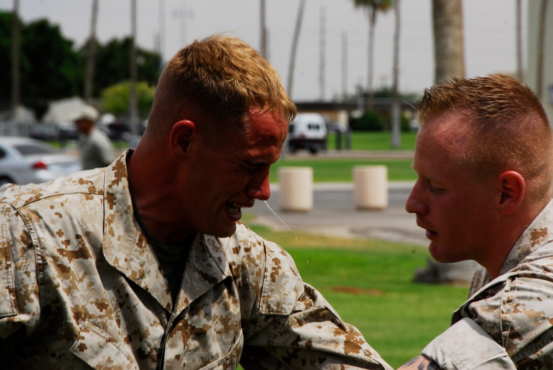Lance Cpl. Jeffrey Hollingsworth, a Marine Air Control Squadron 1 radar technician, fights his way through a circuit course after being sprayed with Oleoresin Capsicum, May 21, 2009 in the martial arts instructor course at Marine Corps Air Station Yuma, Ariz. Each student went through a nine station circuit course after being sprayed with the nonlethal weapon.(Photo by Cpl. Laura A. Mapes)
