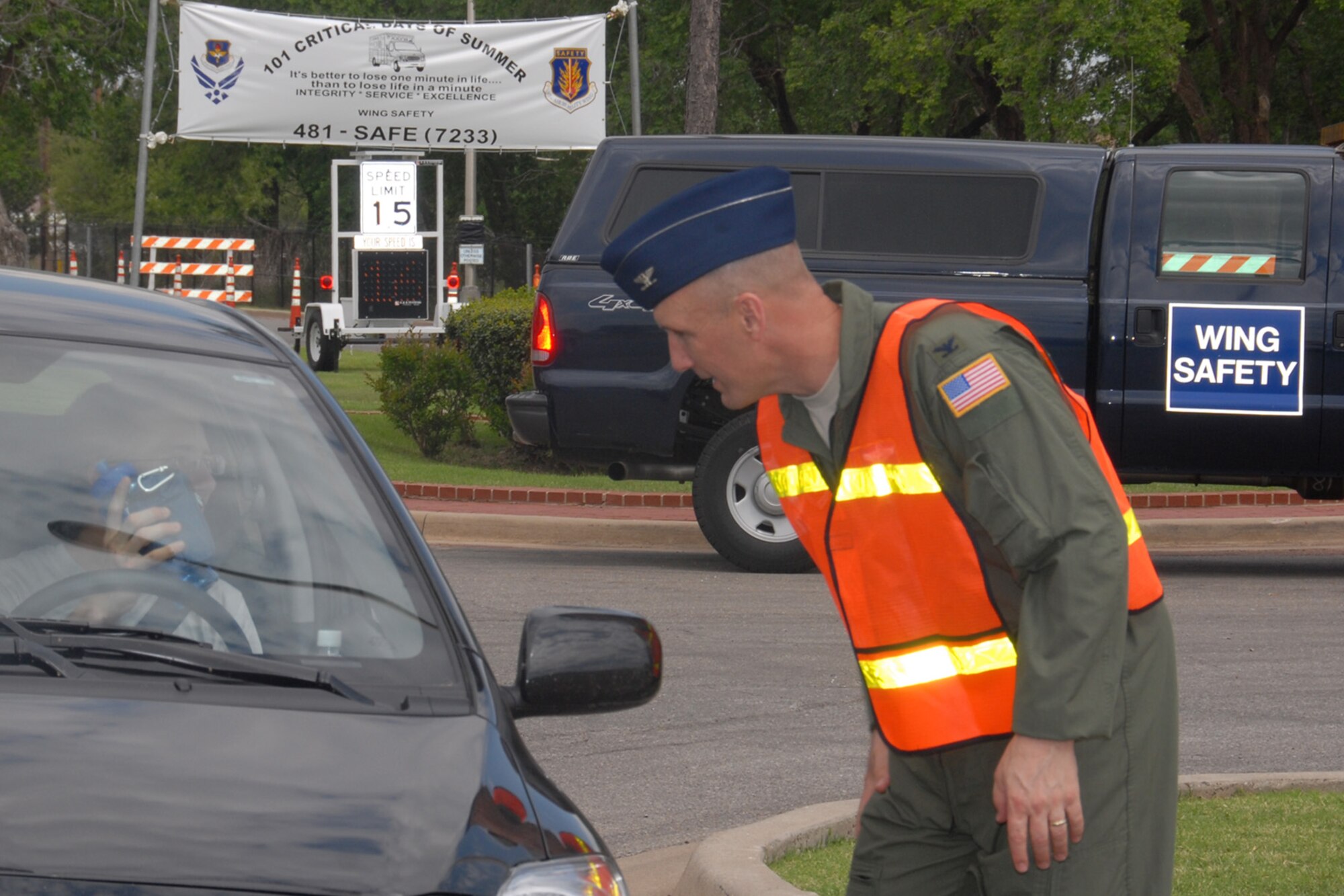 ALTUS AIR FORCE BASE, Okla --- Colonel David W. Allvin, 97 Air Mobility Wing Commander stops vehicles as they leave the base Friday May 22 to hand out safety related items and also reminds passengers to be extra safe over the holiday weekend as part of the 101 Critical Days of Summer kick off.  Items handed out included a water bottle to remind people to remain hydrated and a clip on bag filled with other safety related items. (U.S. Air Force photo by Tech. Sgt. Brian M. Boisvert)
