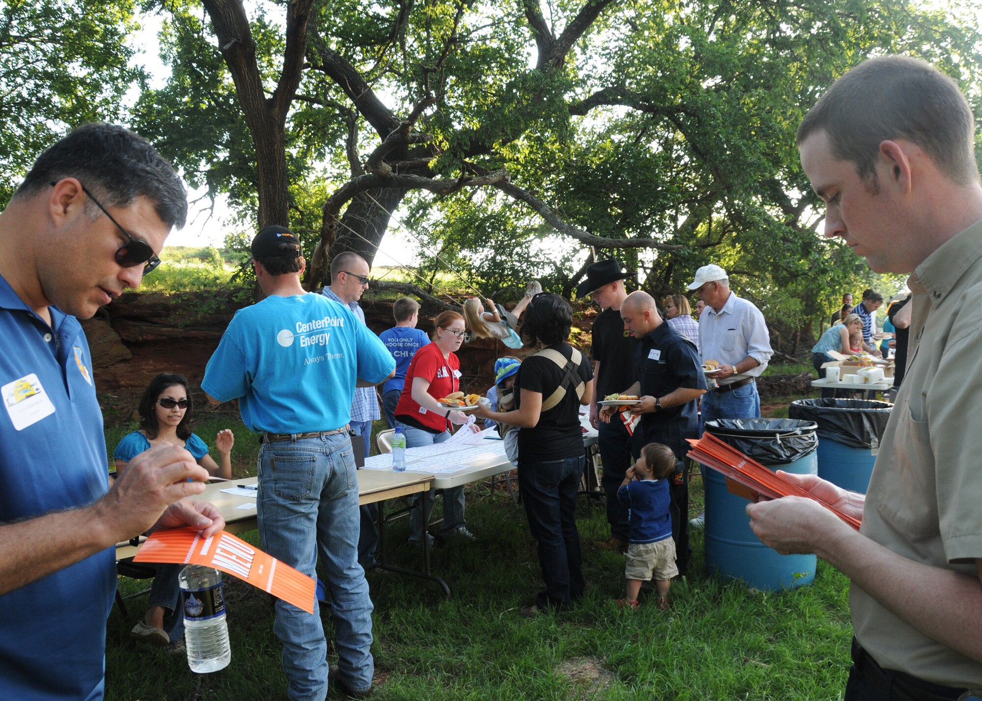 ALTUS AIR FORCE BASE, Okla. -- Lt.Col. Michael Babyak (left), 97th Air Mobility Wing director of staff, receives coupons and menu from a local fast food representative during the Committee of 100 Dinner held at Lucas Farms outside of Altus, Okla., May 21. The Dinner is a free quarterly event sponsored by members of Altus to welcome newly assigned Airmen and their families to the area. The Committee members provided burgers, hotdogs and refreshments. Airmen also participated in horse rides and hayrides during the event. (U.S. Air Force photo/Airman 1st Class Tiffany M. Deuel)