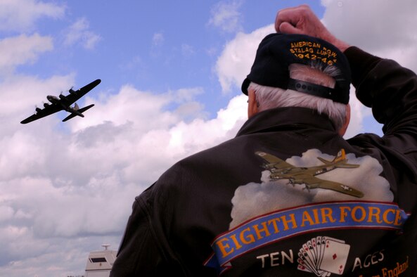 Lloyd Krueger, a 95th Bombardment Group lead navigator, waves at a B-17 flying overhead. After the grand opening of Royal Air Force Horham May 17, the visitors drove out to the old runway where the aircraft flew by. Mr. Krueger said that he?s flown in a B-17 at least once a year since 1944 because ?I can?t let it go and I have to try to get everyone involved.? The aircraft was flown from the Duxford Air Museum.  (U.S. Air Force photo by Staff Sgt. Nathan Gallahan)