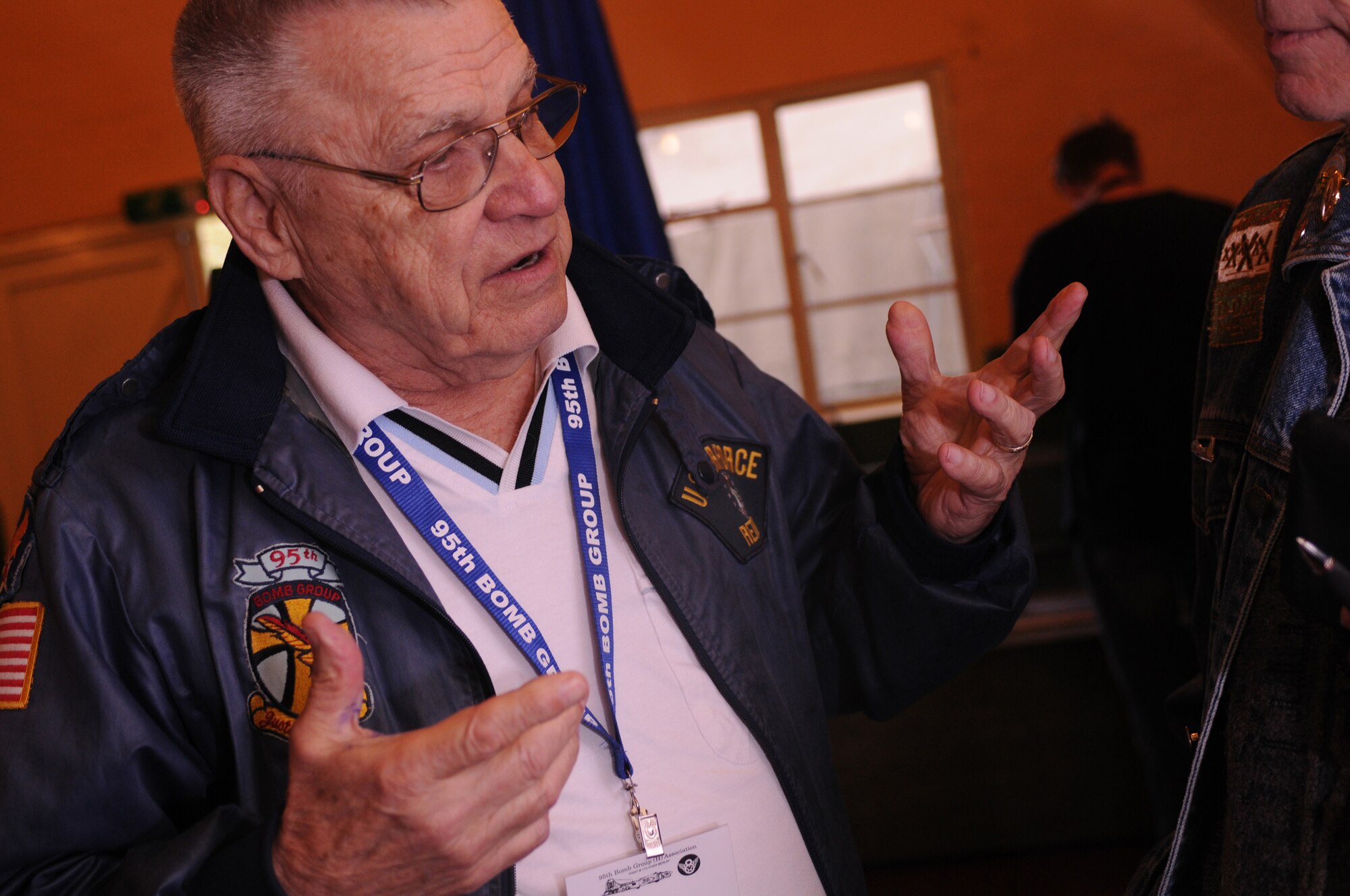 Lloyd Krueger, a 95th Bombardment Group lead navigator, talks with a supporter about his actions during World War II. He flew from the United States to visit Royal Air Force Horham during its grand opening, which happens annually. (U.S. Air Force photo by Staff Sgt. Nathan Gallahan)