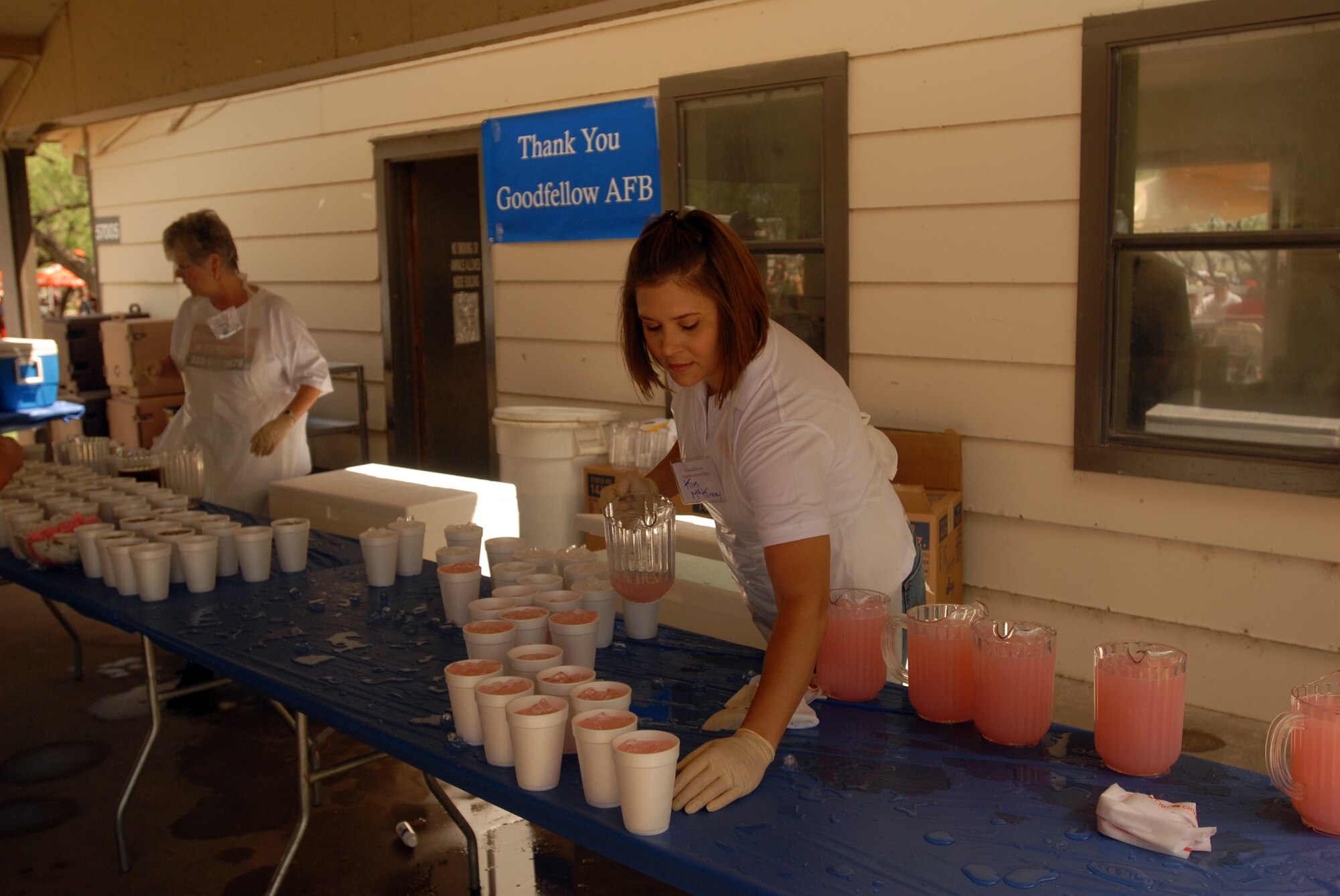 Volunteers from the San Angelo community serve lemonade and iced tea at the Goodfellow Appreciation Day Picnic May 16, Armed Forces Day, at the Goodfellow Recreation Camp at Lake Nasworthy. (U.S. Air Force photo by Airman Clayton Lenhardt)