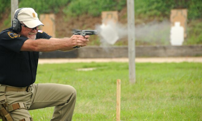 ALTUS AIR FORCE BASE, Okla. -- Phillip Beauchamp, Jackson County Sherriff’s Office deputy, fires a Smith and Wesson 9mm pistol at the “Shoot-Out” competition held at Altus Police Department firing range May 14. Mr. Beauchamp was awarded “Top Shooter” of the day by completing the target course in 68.65 seconds. Shoot-out included officers from the 97th Security Forces Squadron, Office of Special Investigations and Jackson County Sherriff’s Office in support of police week. (U.S. Air Force photo/Senior Airman Cherice Bryant)