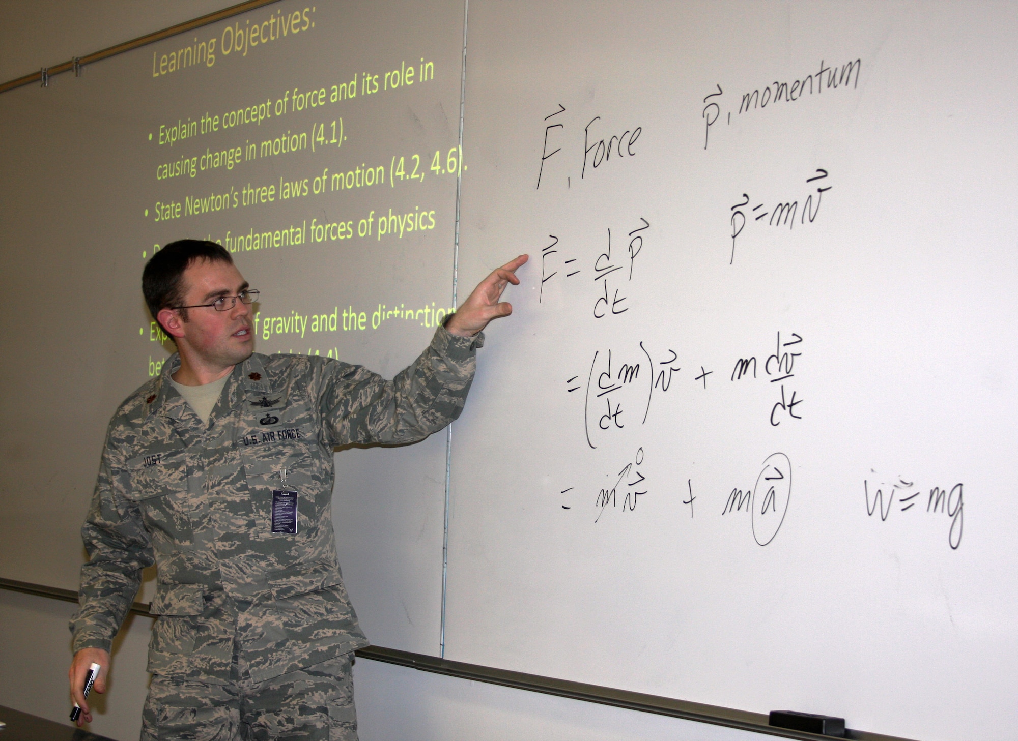 Maj. Thomas Jost leads cadets through a core physics class at the U.S. Air Force Academy in Colorado Springs, Colo., Jan. 16. As cadets learn about Newton's laws of gravitation, they also learn valuable lessons about determination and perseverance. (U.S. Air Force photo/Arnie Spencer)