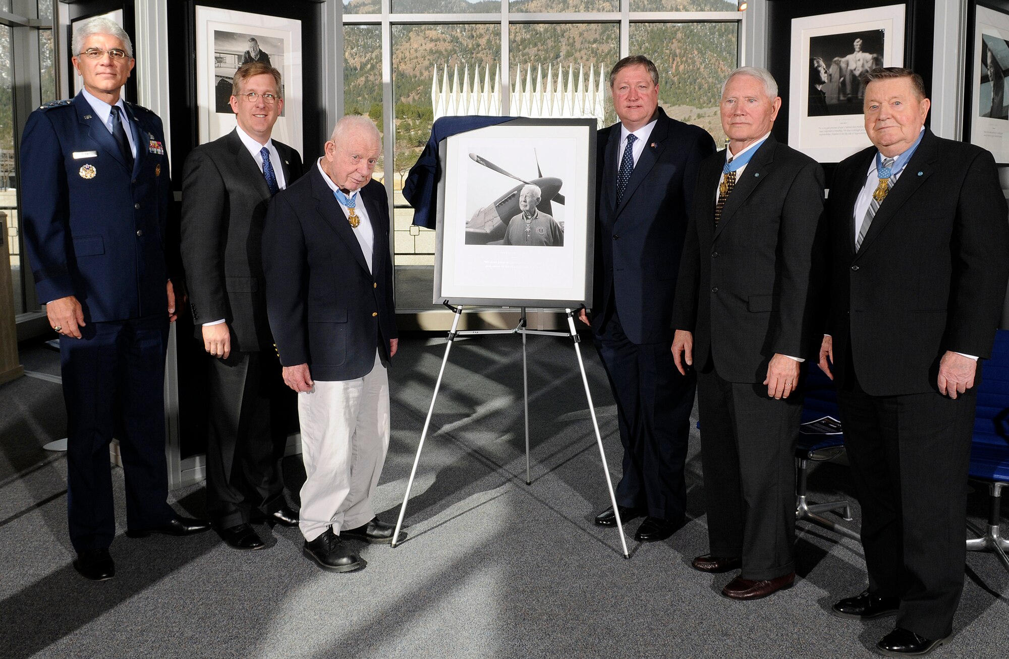 Secretary of the Air Force Michael Donley and retired Col. Bernard Fisher unveil a portrait of Colonel Fisher during the Visions of Valor dedication at the U.S. Air Force Academy in Colorado Springs, Colo., April 3. Pictured here (left to right) are Lt. Gen. John F. Regni, Academy superintendent; David McIntyre, CEO of TriWest Healthcare Alliance, Colonel Fisher, Secretary Donley and retired Cols. Leo Thorsness and Joe Jackson. Colonels Fisher, Thorsness and Jackson are all Congressional Medal of Honor recipients: Colonel Fisher is the first living Airman to receive the Medal of Honor, which he received for heroism during the Vietnam War. (U.S. Air Force photo/Mike Kaplan)