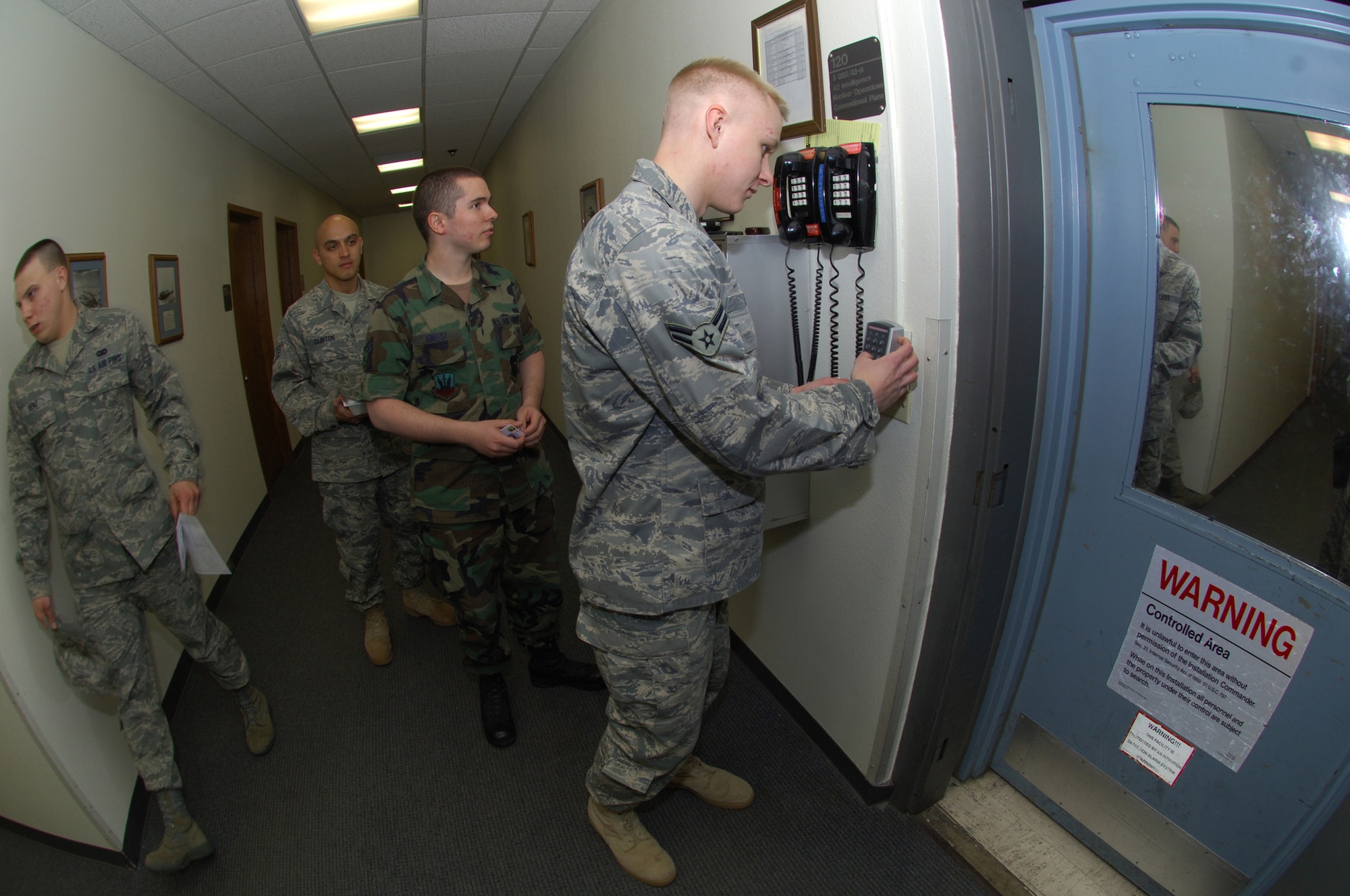 MINOT AIR FORCE BASE, N.D. -- (front to back) Senior Airman Josef Kniesz, Airman 1st Class Andrew Pries and Staff Sgt. Russell Clinton, 5th Operations Support Squadron, prepare to enter a secure area during a Nuclear Surety Inspection, here May 16. An NSI is designed to evaluate a unit's readiness to execute nuclear operations. Areas to be evaluated during the NSI include operations, maintenance, security, and support activities needed to ensure the wing performs its mission in a safe, secure and reliable manner. This no-notice inspection concluded May 22. (U.S. Air Force Photo by Tech. Sgt. Lee A. Osberry Jr.)