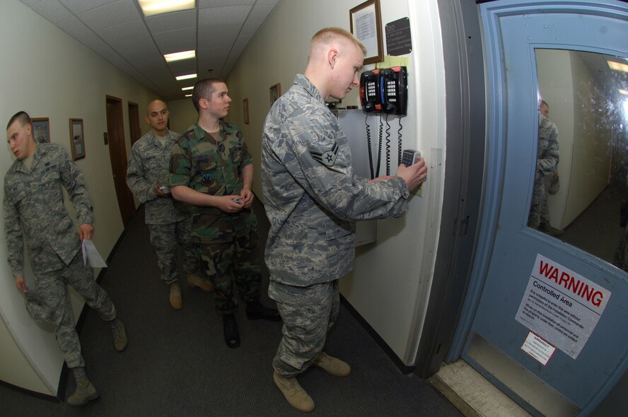MINOT AIR FORCE BASE, N.D. -- (front to back) Senior Airman Josef Kniesz, Airman 1st Class Andrew Pries and Staff Sgt. Russell Clinton, 5th Operations Support Squadron, prepare to enter a secure area during a Nuclear Surety Inspection, here May 16. An NSI is designed to evaluate a unit's readiness to execute nuclear operations. Areas to be evaluated during the NSI include operations, maintenance, security, and support activities needed to ensure the wing performs its mission in a safe, secure and reliable manner. This no-notice inspection concluded May 22. (U.S. Air Force Photo by Tech. Sgt. Lee A. Osberry Jr.)