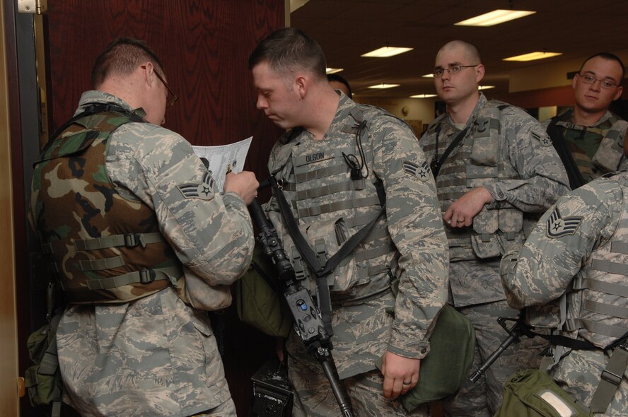 MINOT AIR FORCE BASE, N.D. -- Members of the 5th Security Forces Squadron and 5th Munitions Squadron prepare for a weapons transportation convoy briefing during a Nuclear Surety Inspection here May 15. An NSI is designed to evaluate a unit's readiness to execute nuclear operations. Areas to be evaluated during the NSI include operations, maintenance, security, and support activities needed to ensure the wing performs its mission in a safe, secure and reliable manner. This no-notice inspection concluded May 22. (U.S. Air Force Photo by Staff Sgt. Sergeant Stacy Moless)