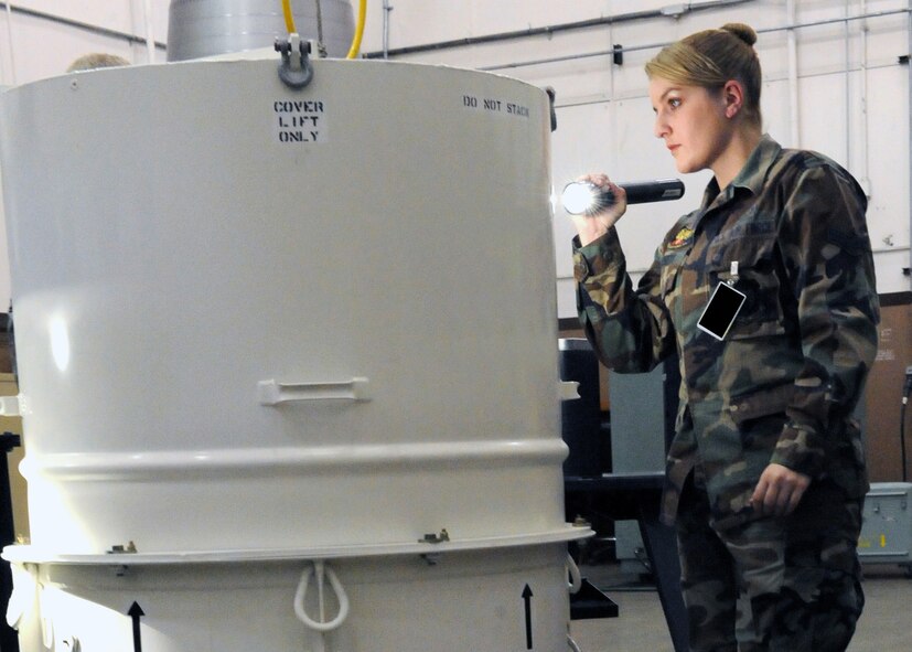 MINOT AIR FORCE BASE, ND -- Airman First Class Randee Puckett, 5th Munitions Squadron re-entry system/re-entry vehicle journeyman, inspects the outside of a storage and transportation container for imperfections during the Nuclear Surety Inspection here May 16. The base's first no-notice Nuclear Surety Inspection concluded on 22 May, with an announcement that the wing recieved a satisfactory rating. 2009 was a year that brought progress and a renewed emphasis on safe, secure and reliable nuclear operations. The 91st Missile Wing transitioned to Air Force Global Strike Command with the 5th Bomb Wing scheduled to follow suit in 2010. . (US Air Force photo by Staff Sgt. Keith Ballard)