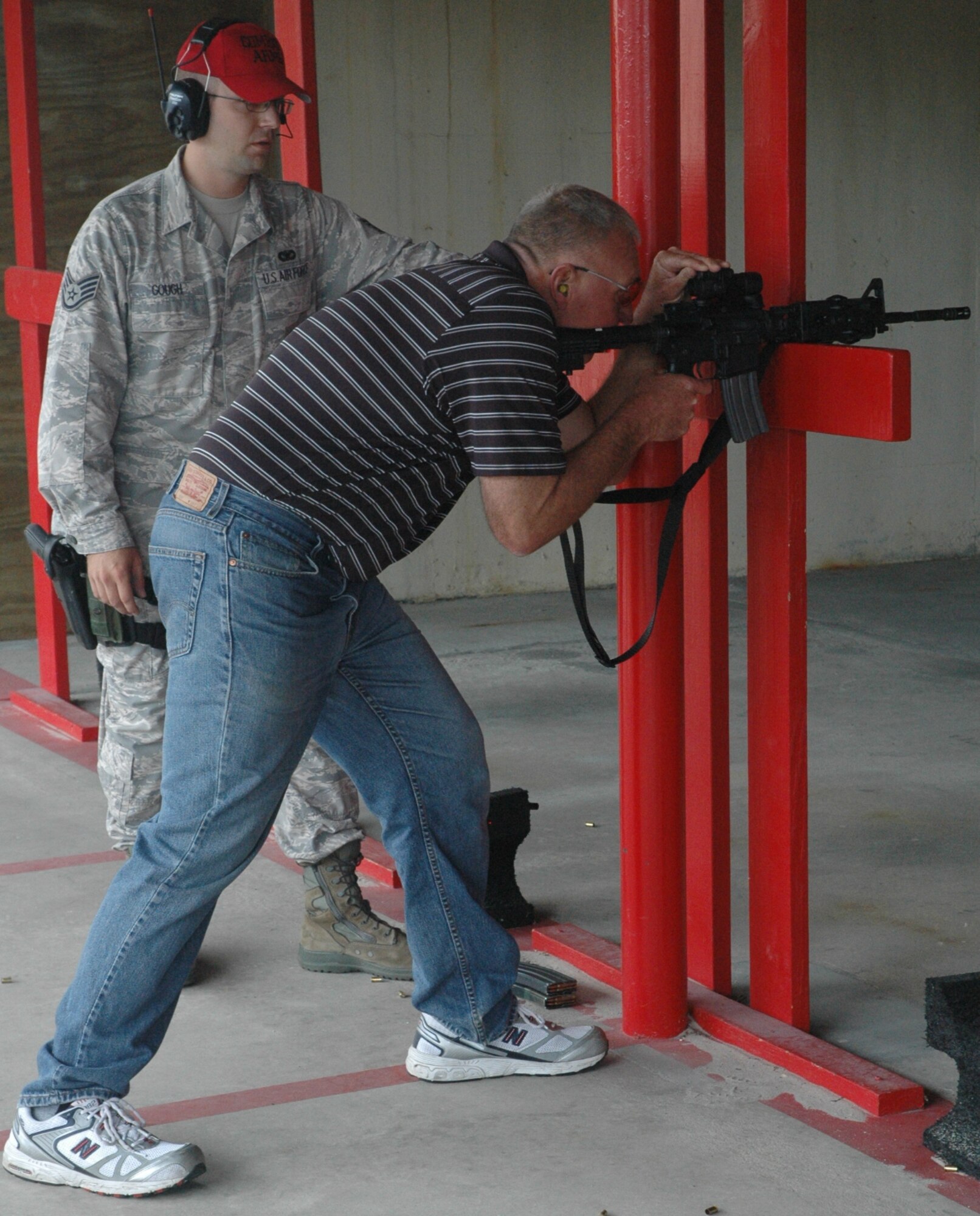 Staff Sgt. Simeon Gough, 325th Security Forces Squadron Combat Arms scheduler, instructs Todd Bender, world-class skeet shooter, how to fire the M4 rifle Thursday.  “Mr. Bender provides a great service to Americans while teaching important shooting fundamentals and it was a great honor of mine to have the opportunity to show him some of the Air Force’s weapon systems,” said Sergeant Gough.  (U.S. Air Force photo/ Senior Airman Anthony J. Hyatt)