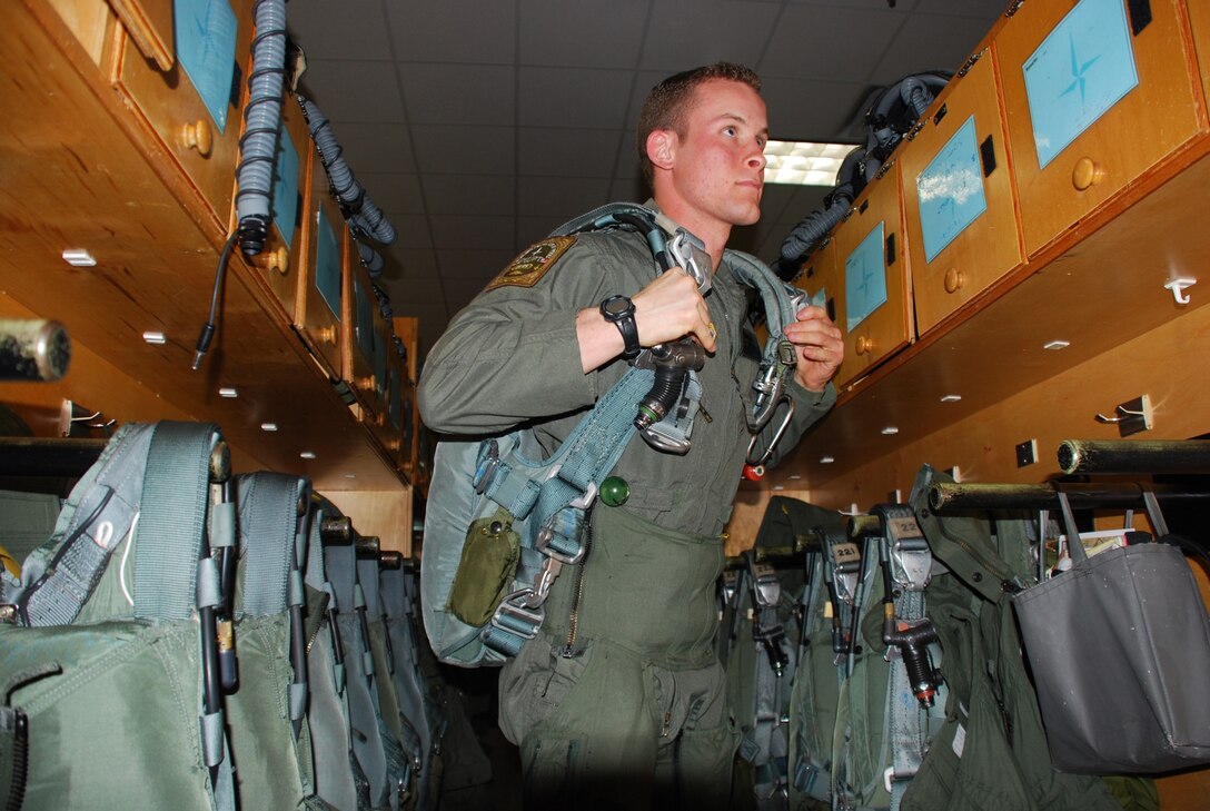 Second Lt. Jared Thibault, a student pilot at the 80th Operations Support Squadron, prepares for training by getting suited up. The gear and equipment Lieutenant Thibault is wearing has been inspected five times by the Aircrew Flight Equipment team.  (U.S. Air Force photo/ Airman 1st Class Valerie Hosea)
