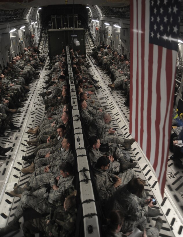 In a C-17 Globemaster III,  Airmen from the 375th Airlift Wing return home May 17 to Scott Air Force Base from Volk Field, Wis.  Active-duty, Air National Guard and Reserve Airmen were at Volk Field to participate in a week-long training exercise in preparation for an operational readiness inspection next year.  (U.S. Air Force photo/Airman 1st Class Wesley Farnsworth)