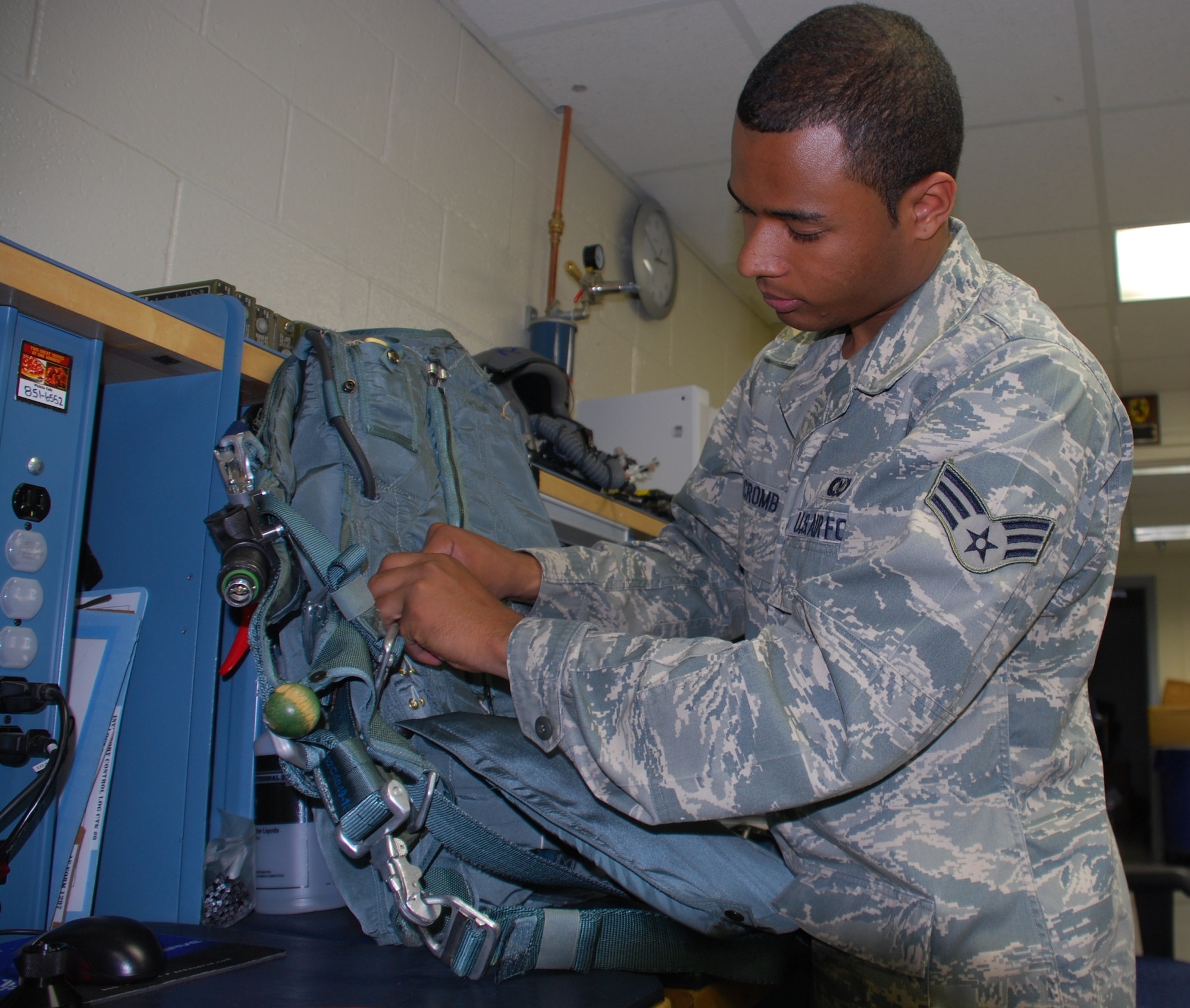 Senior Airman Keith Halcromb, 80th Operations Support Squadron, inspects a parachute while performing Aircrew Flight Equipment daily tasks. The Aircrew Flight Equipment team inspects equipment for more than 690 student and instructor pilots to ensure the equipment works properly. (U.S. Air Force photo/ Airman 1st Class Valerie Hosea)