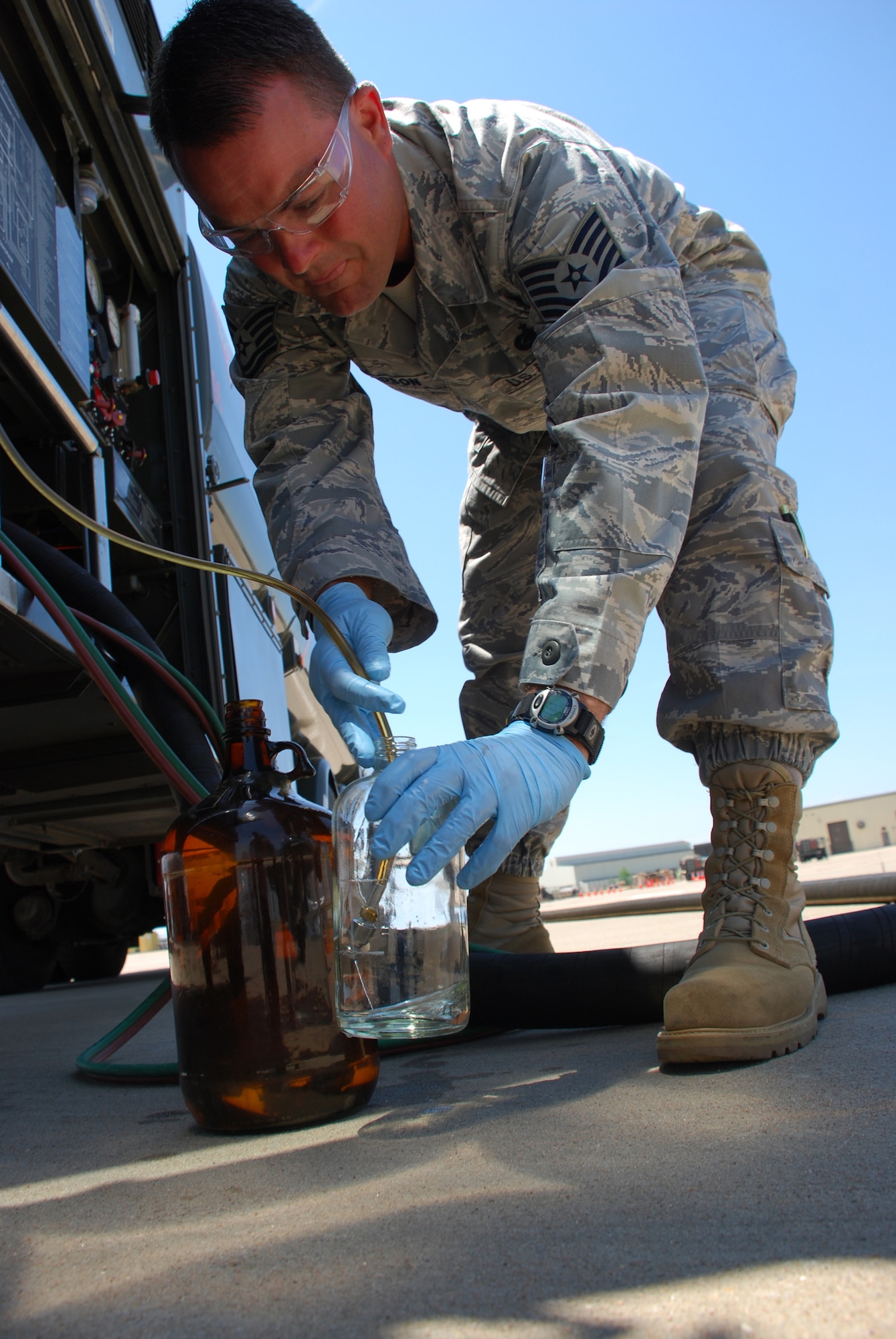 Tech. Sgt. Randy Davidson collects samples of a 50-50 blend of synthetic and JP-8 fuels May 21 at the 364th Training Squadron's fuels training yard. Sergeant Davidson is part of an Air Force Petroleum Agency team that will conduct tests on Sheppard's Type 3 hydrant system as part of the service's synthetic fuel certification process. The tests should be completed in late October or early November. (U.S. Air Force photo/John Ingle)