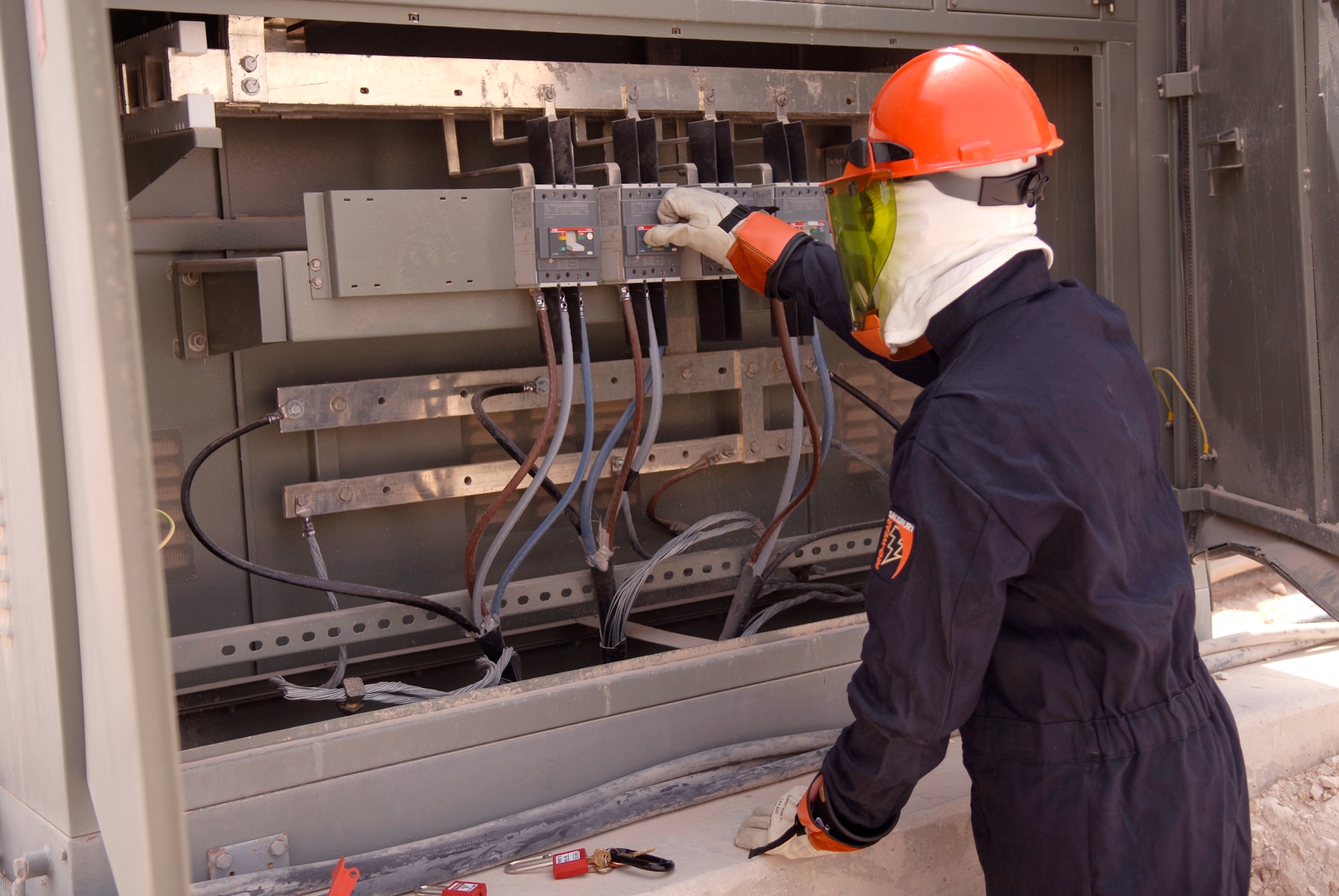 Staff Sgt. Michael Thomas, a 379th Expeditionary Civil Engineer Squadron electrical systems craftsman, turns the breakers on and checks the voltage on a transformer at the new gas-fired turbine power plant, May 21, 2009, at an undisclosed location in Southwest Asia.  The power plant will save millions of dollars annually and help transform the base from expeditionary to enduring.  Sergeant Thomas hails from San Antonio, Texas and is deployed from Joint base McGuire-Dix-Lakehurst, N.J. in support of Operations Iraqi and Enduring Freedom and Combined Joint Task Force - Horn of Africa.  (U.S. Air Force photo/Senior Airman Andrew Satran/released)