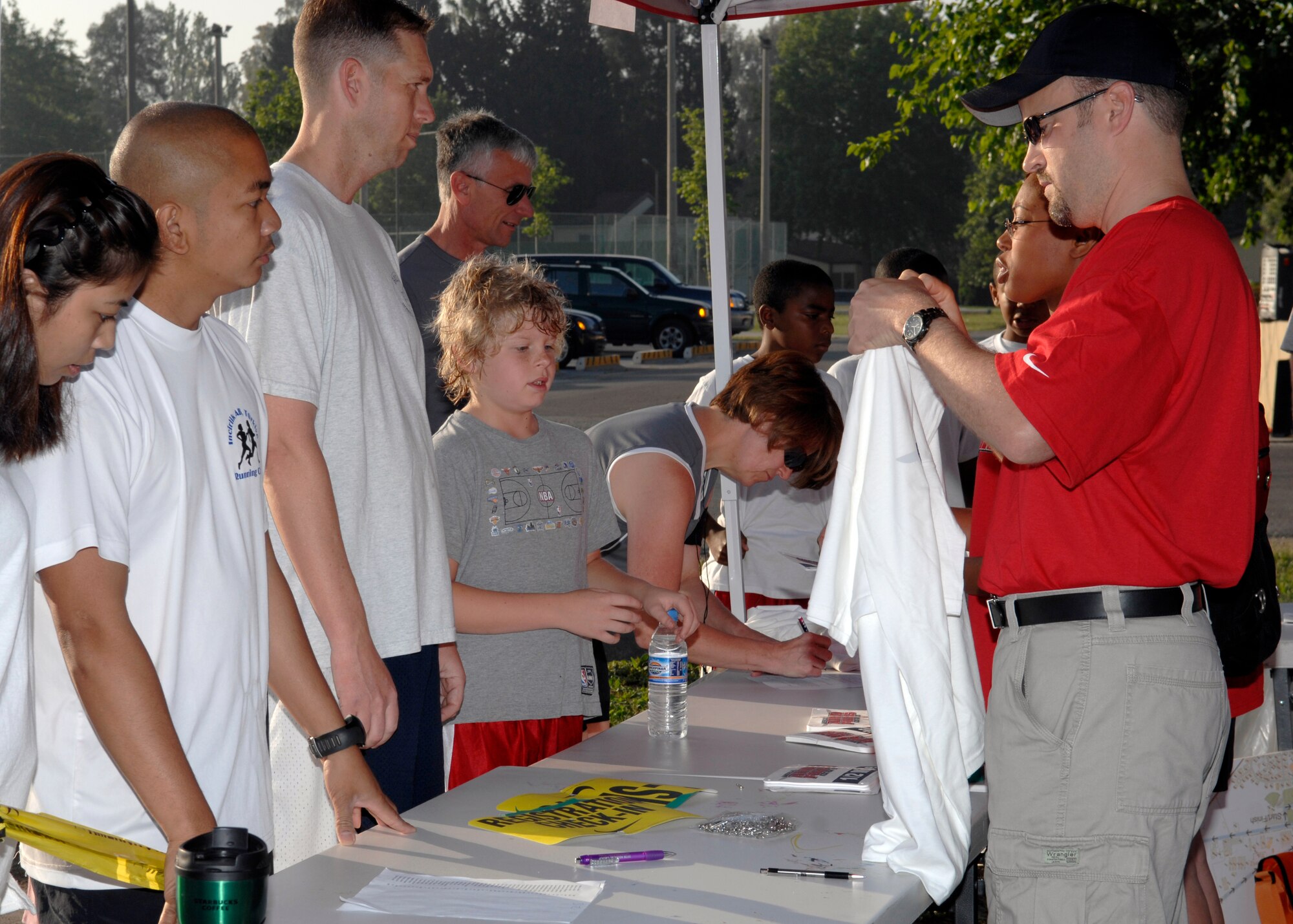 Tim Renegar, Airman and Family Services flight chief, prepares a shirt for an Incirlik Airman prior to the Armed Forces Kids Run Saturday, May 16, 2009. This was the 25th Annual Armed Forces Kids Run observed worldwide, promoting the health and fitness of military children and families. (U.S. Air Force Photo/Master Sgt. Edward D. Holzapfel)