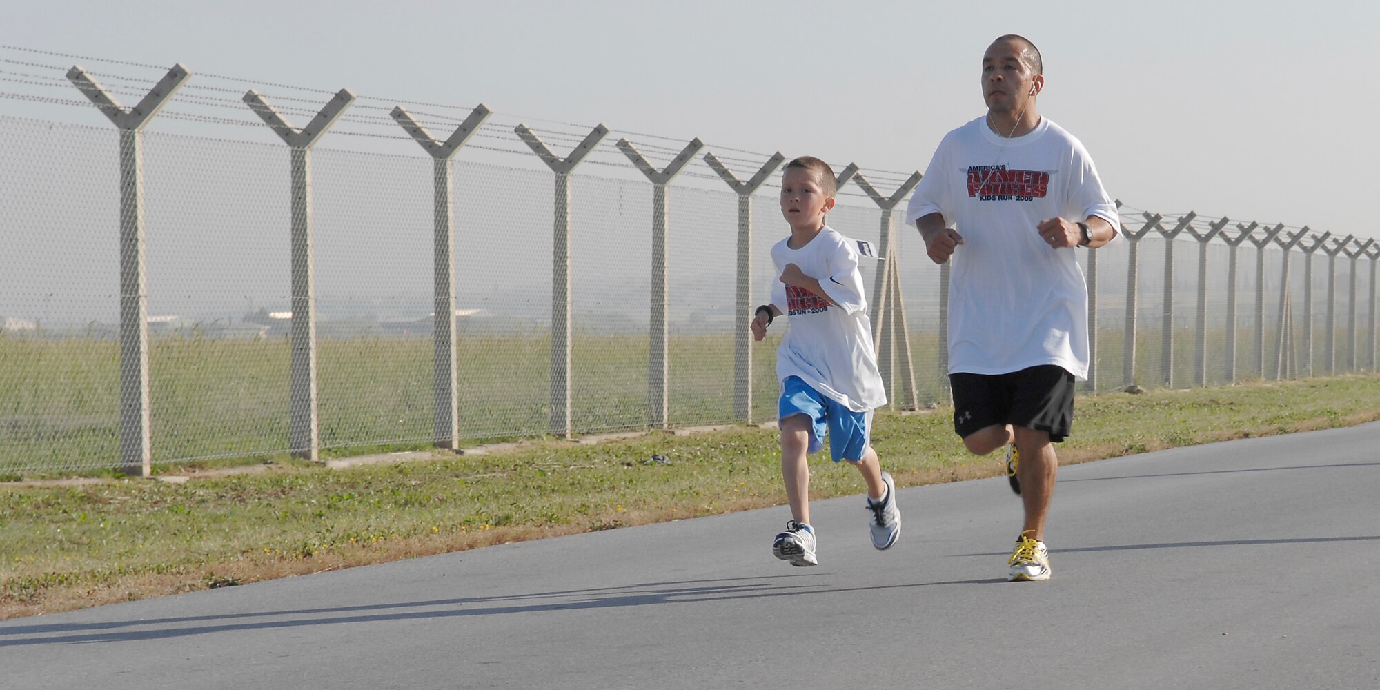Staff Sgt. Amado Vigliante, 39th Communication Squadron, and son Jacob raced around the Incirlik Physical Training Triangle during the Armed Forces Kids Run Saturday, May 16, 2009. This was the 25th Annual Armed Forces Kids Run observed worldwide, promoting the health and fitness of military children and families. (U.S. Air Force Photo/Master Sgt. Edward D. Holzapfel)
