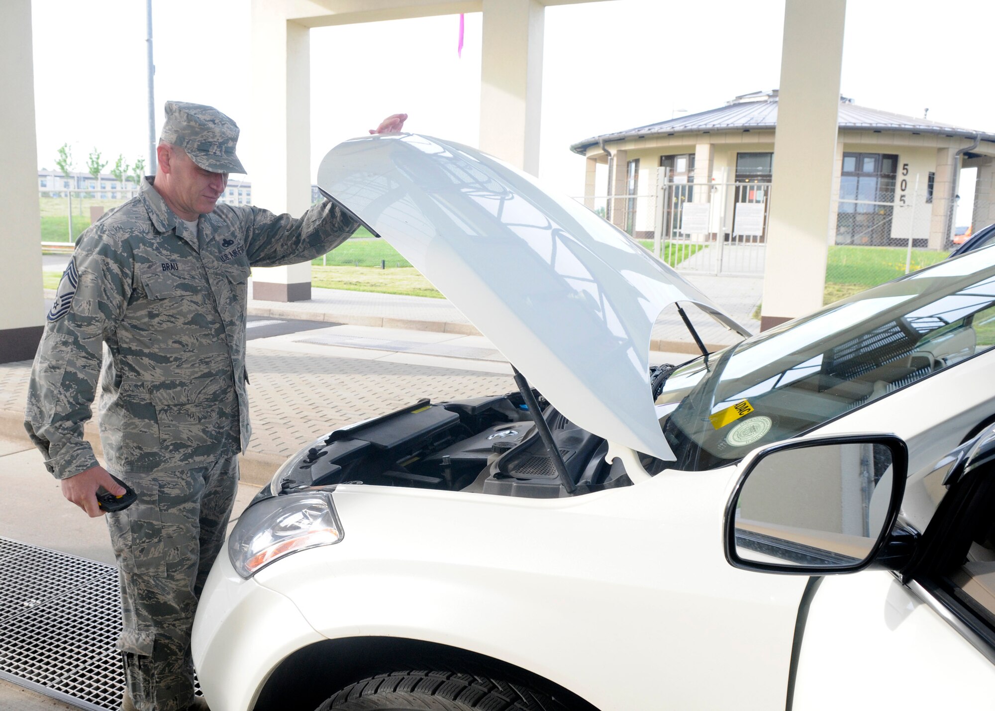 SPANGDAHLEM, Germany – Chief Master Sgt. David Brau, 52nd Component Maintenance Squadron, assists with a random vehicle inspection as part of the “walk in their shoes” program May 20, 2009. The newly created program allows Chiefs to experience different aspects of the base. (U.S. Air Force photo by Airman 1st Class Staci Miller)